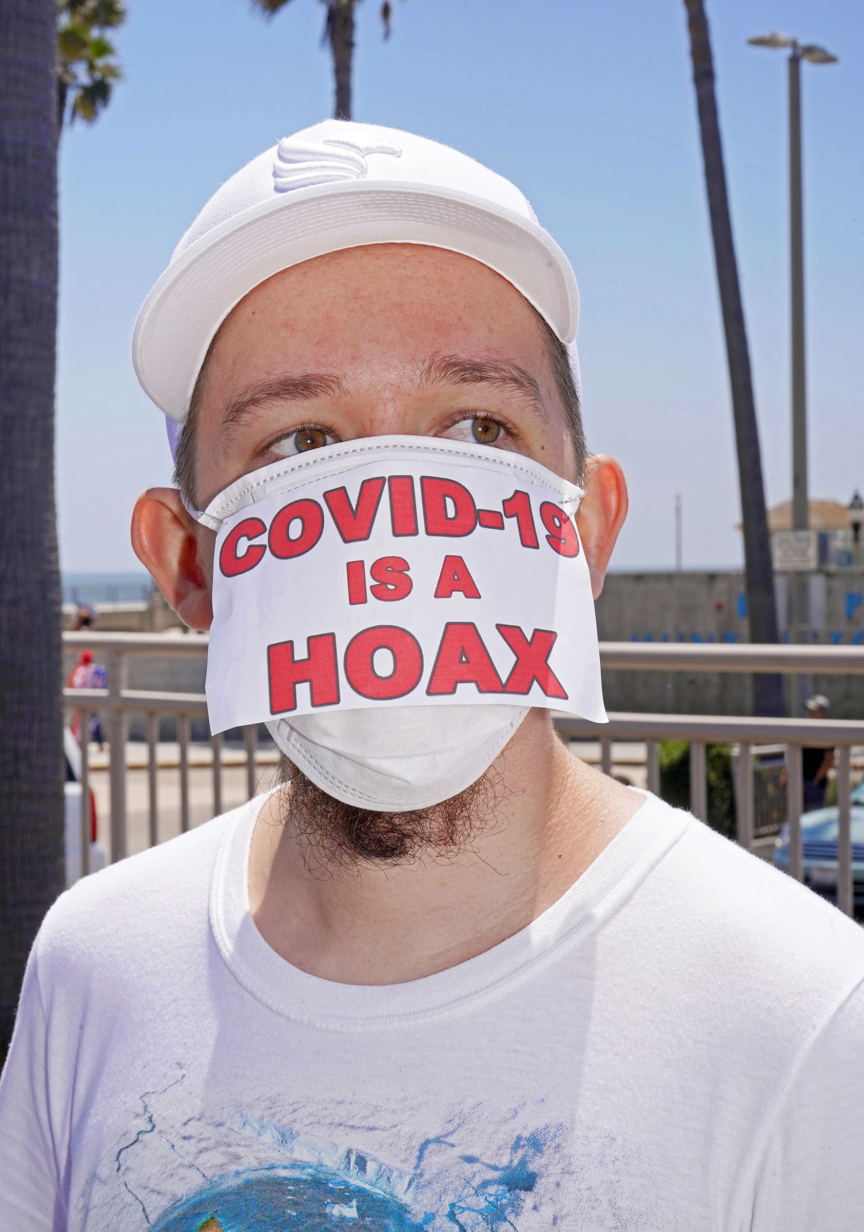 Conspiracy theories and misinformation on display at anti-lockdown rally in Huntington Beach, Calif., May 1, 2020.