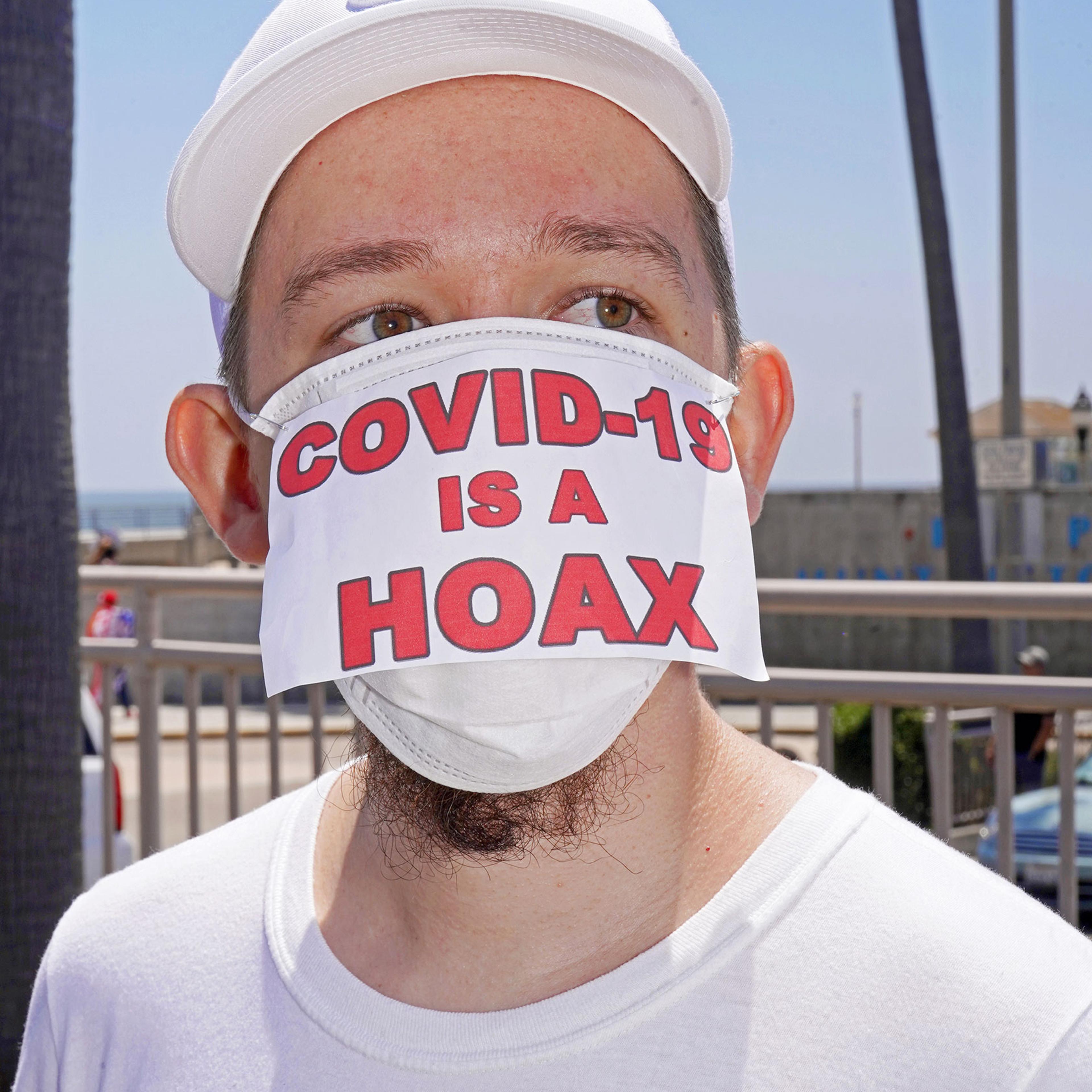 Conspiracy theories and misinformation on display at anti-lockdown rally in Huntington Beach, Calif., May 1, 2020.