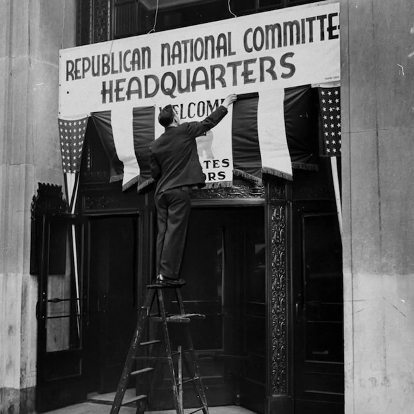 Worker puts up sign for the Republican National Convention C