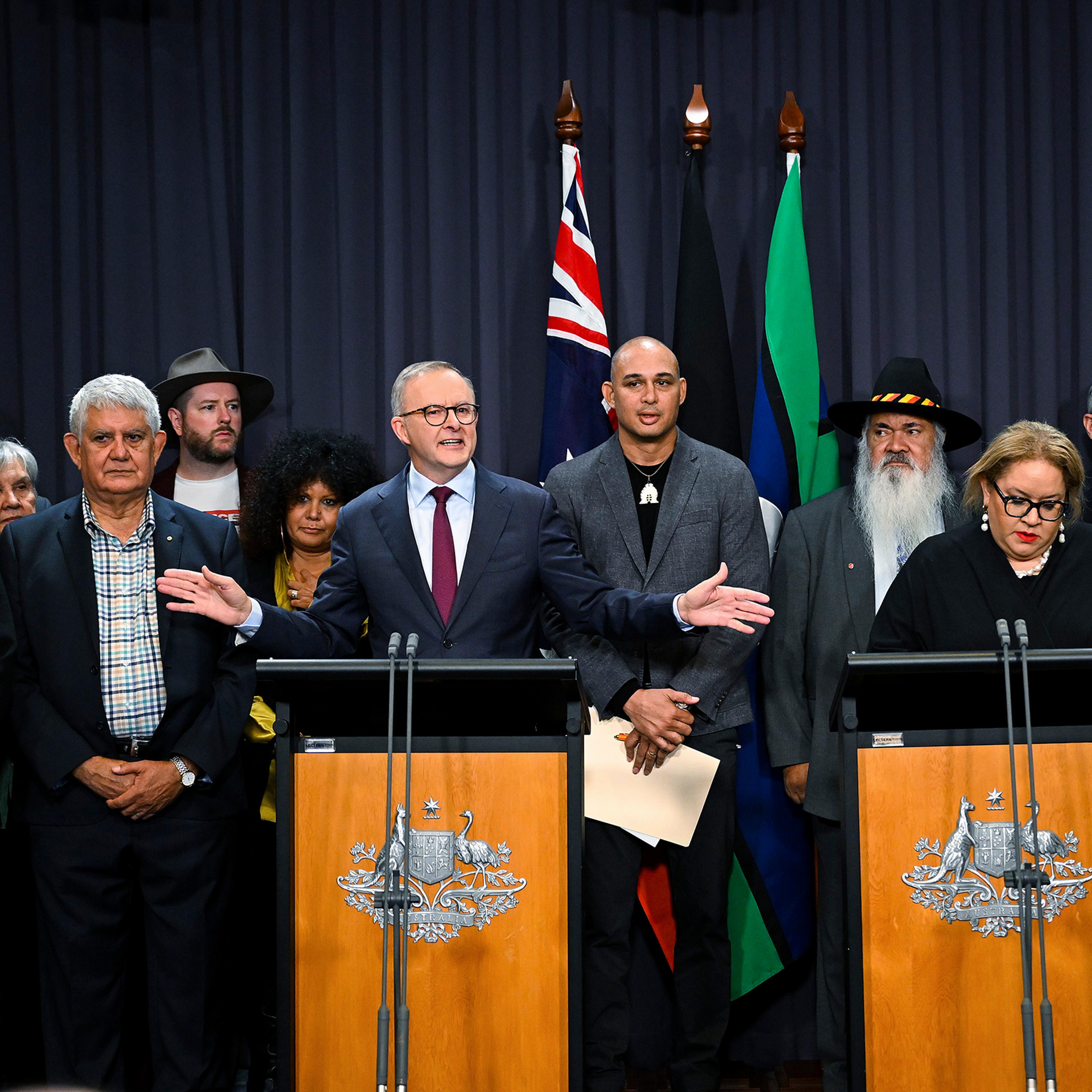 Australian Prime Minister Anthony Albanese, at the left podium, is surrounded by members of the First Nations Referendum Working Group during a press conference at Parliament House in Canberra, Australia, on March 23, 2023.