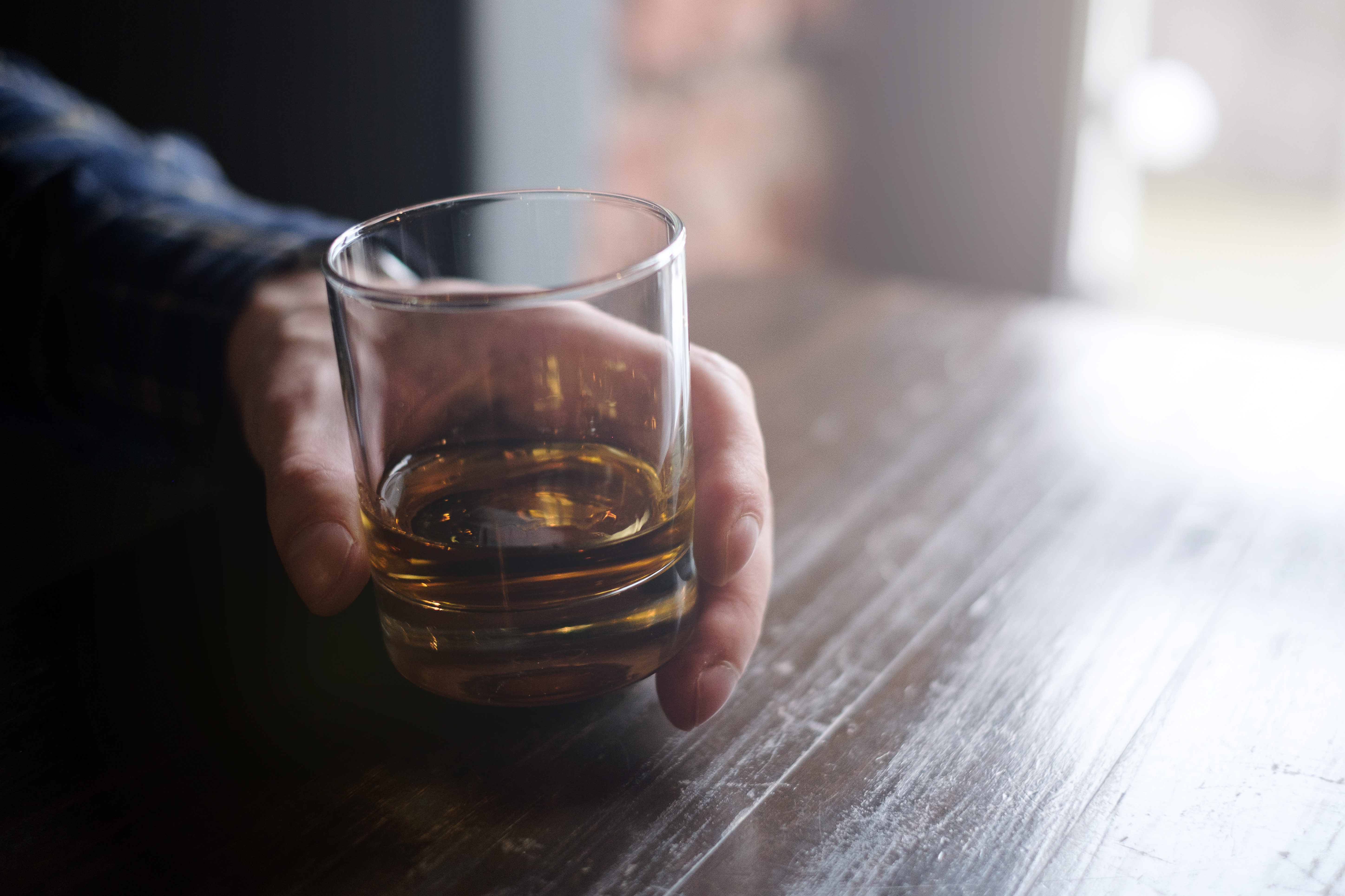 Man holding glass of whiskey