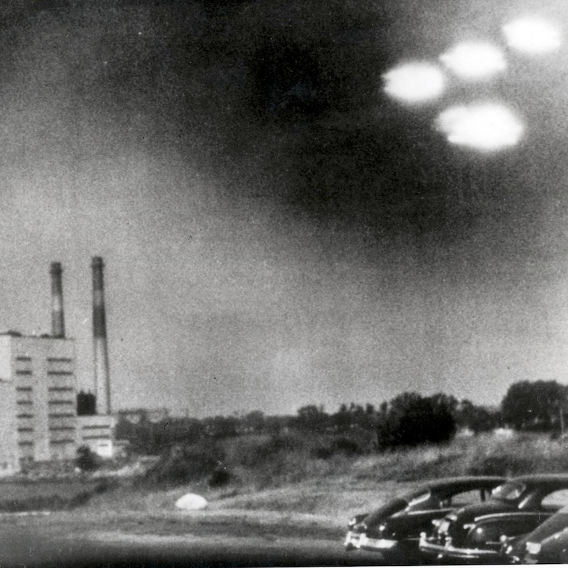 Salem, Massachusetts, USA. 3rd August, 1952. This picture, taken through the window of a laboratory by a 21 year old U.S. coastguard, shows four unidentified flying objects as bright lights in the sky. Many American's believe them to be flying saucers.