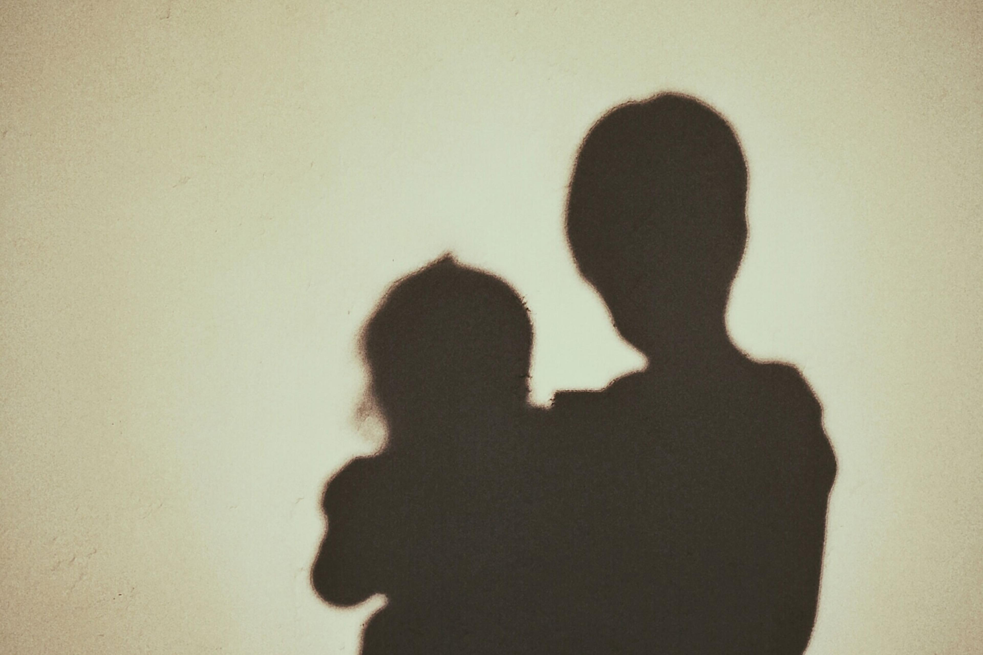 Shadow Of Mother And Daughter On Wall