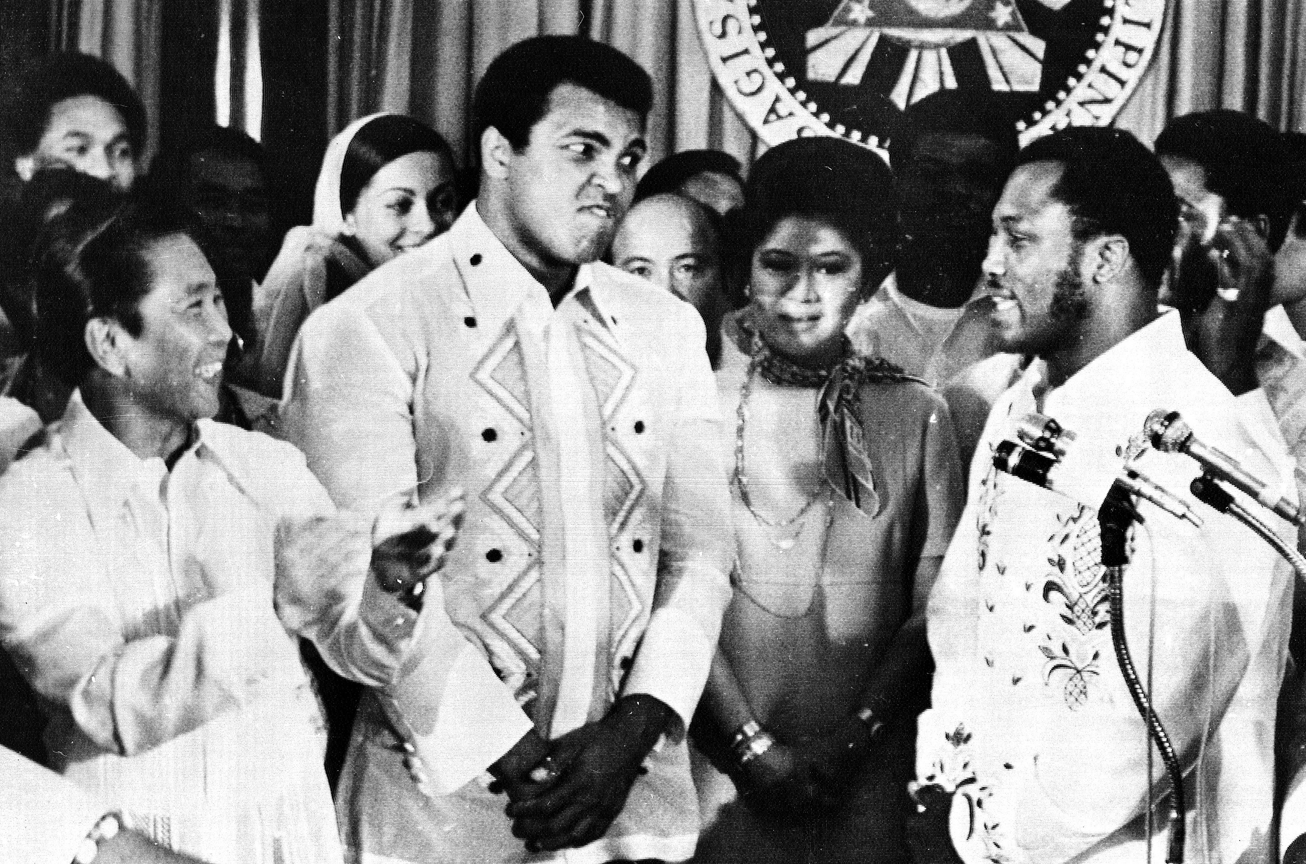 Philippines President Ferdinand Marcos, left, applauds as challenger Joe Frazier, right, makes some remarks about world champion Muhammad Ali, second from left, during their call on Marcos at the Malacanang Palace in Manila, Philippines, on Sept. 18, 197