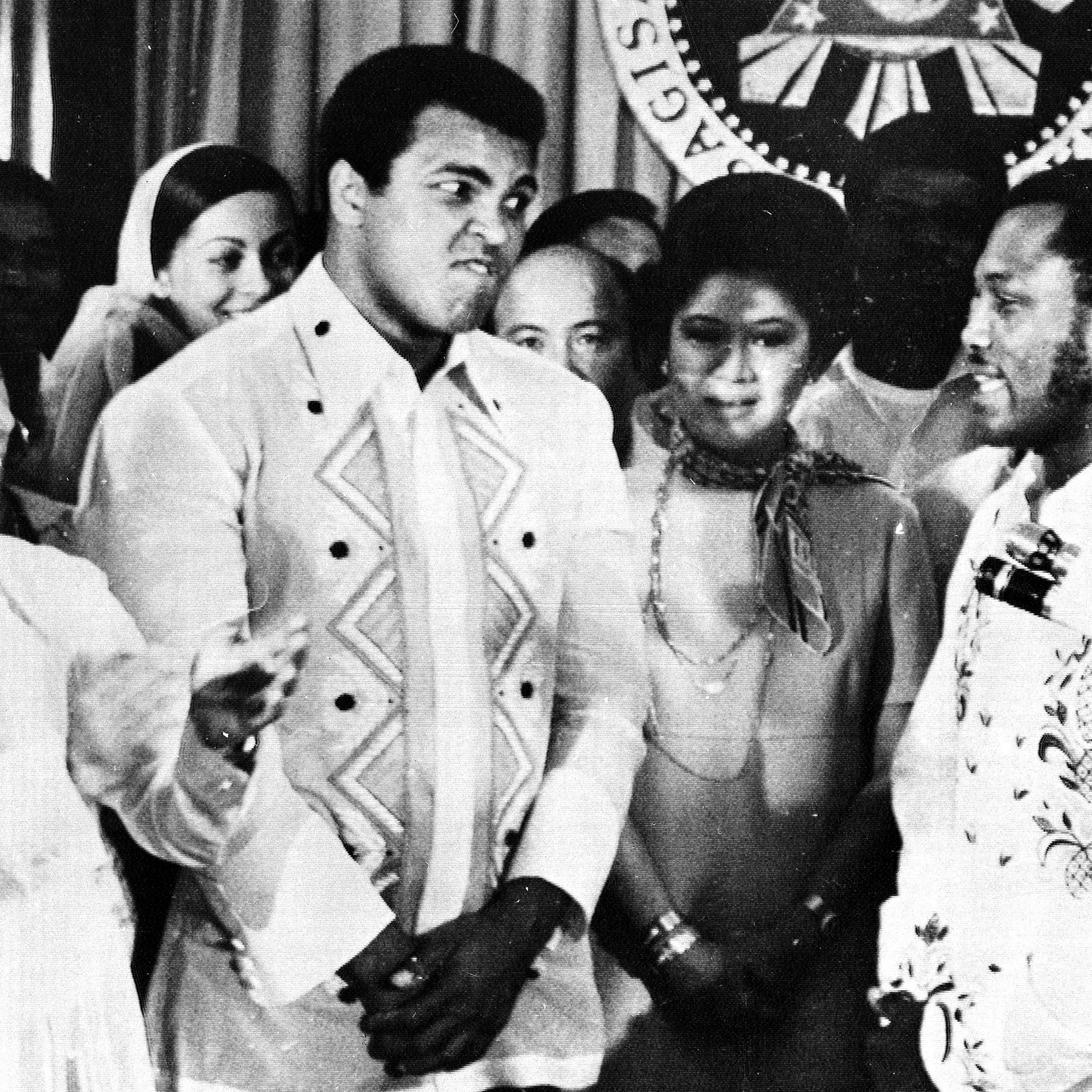 Philippines President Ferdinand Marcos, left, applauds as challenger Joe Frazier, right, makes some remarks about world champion Muhammad Ali, second from left, during their call on Marcos at the Malacanang Palace in Manila, Philippines, on Sept. 18, 197