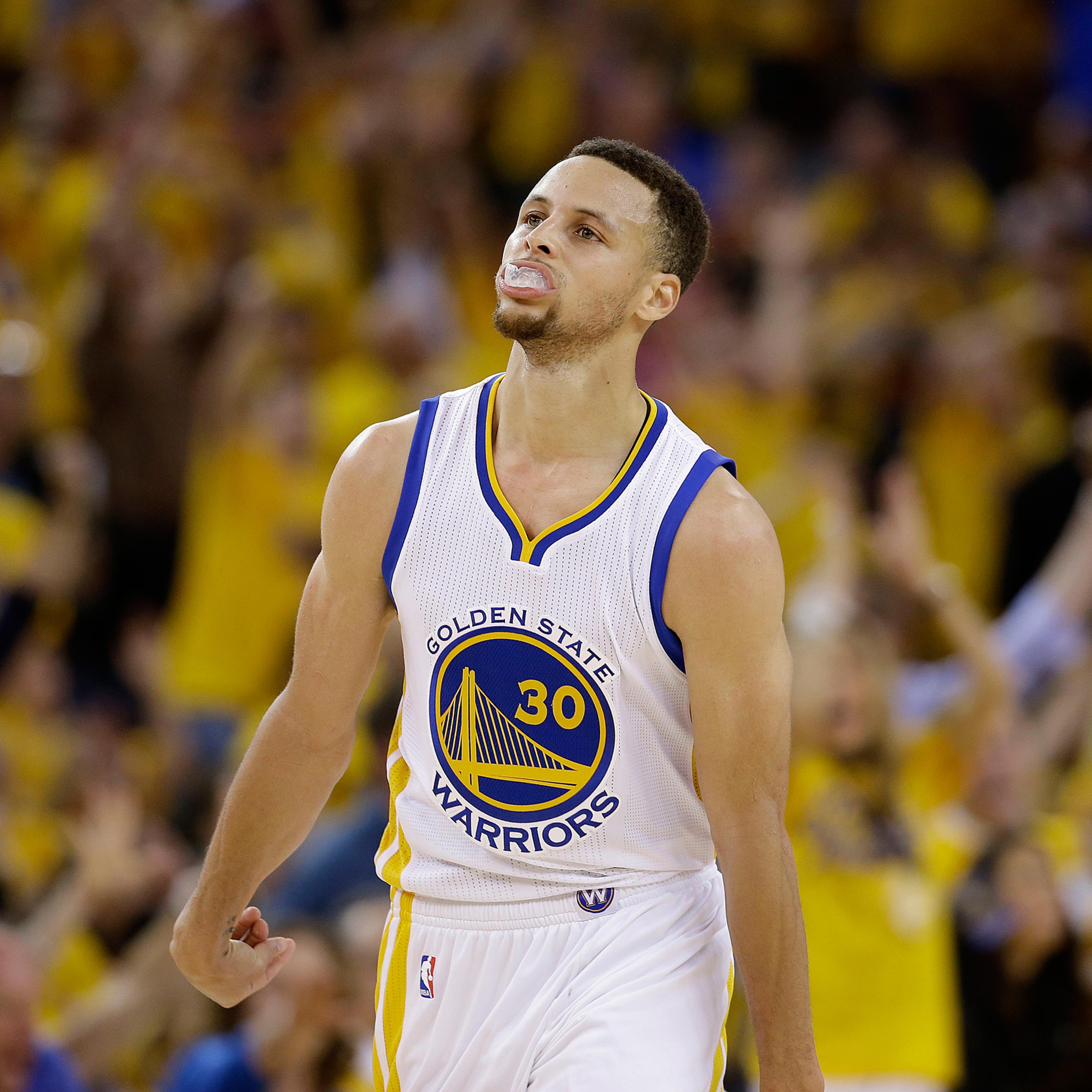 Golden State Warriors guard Stephen Curry (30) reacts after scoring against the Oklahoma City Thunder during the first half of Game 1 of the NBA basketball Western Conference finals in Oakland, Calif., Monday, May 16, 2016. (AP Photo/Marcio Jose Sanchez)