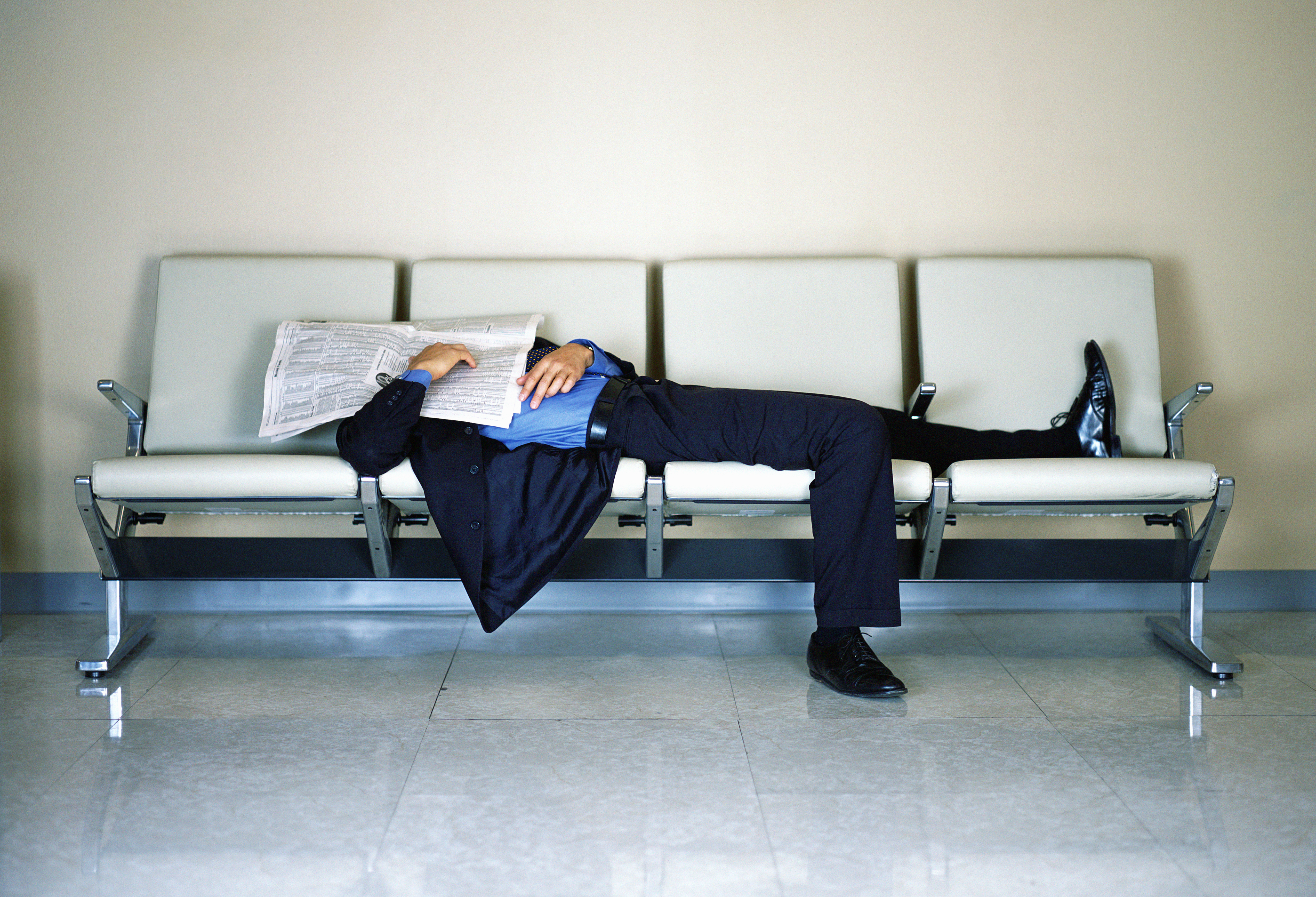 Businessman Sleeping at Airport