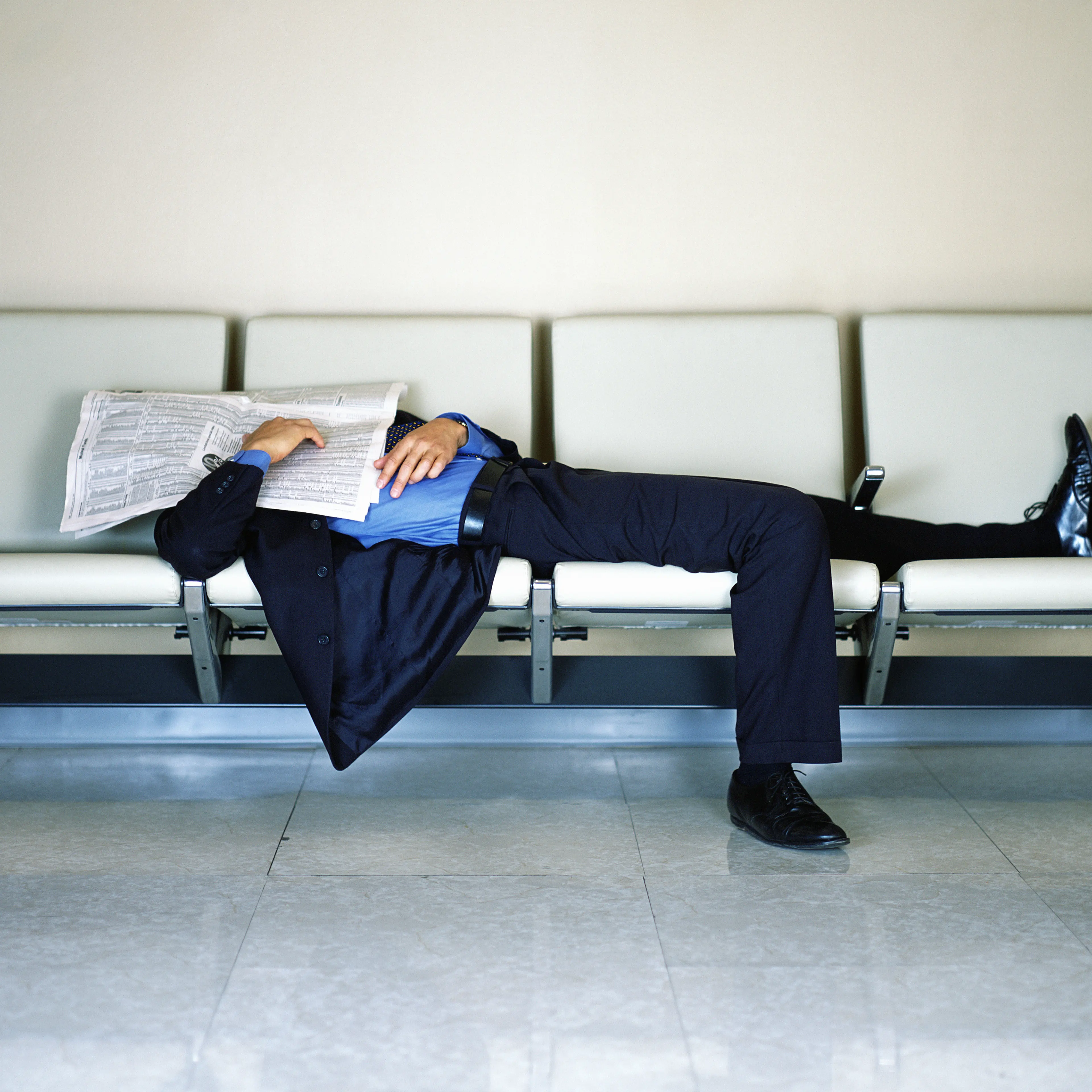 Businessman Sleeping at Airport