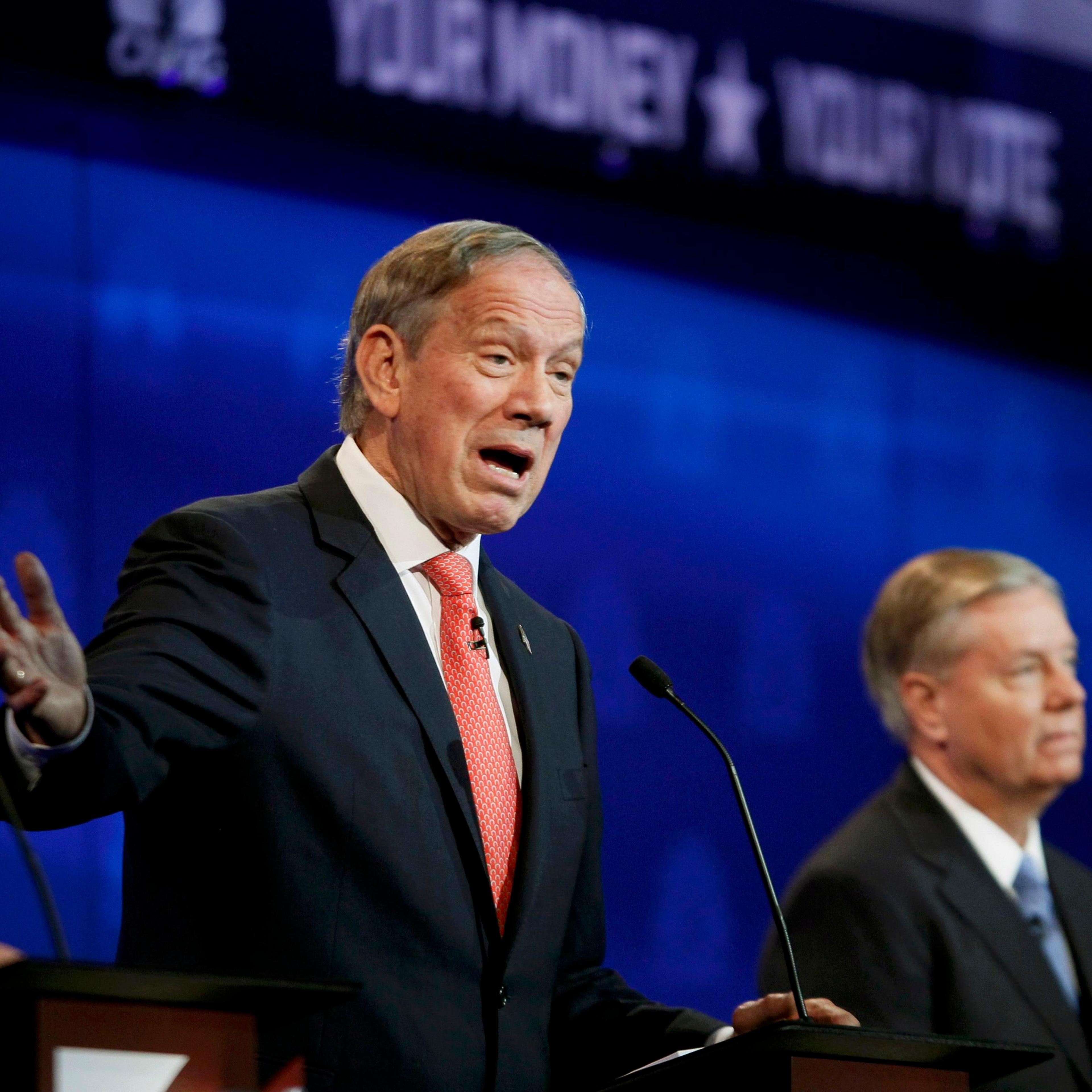 Republican U.S. presidential candidate Pataki speaks as Graham listens at a forum for lower polling candidates held by CNBC before the main debate in Boulder