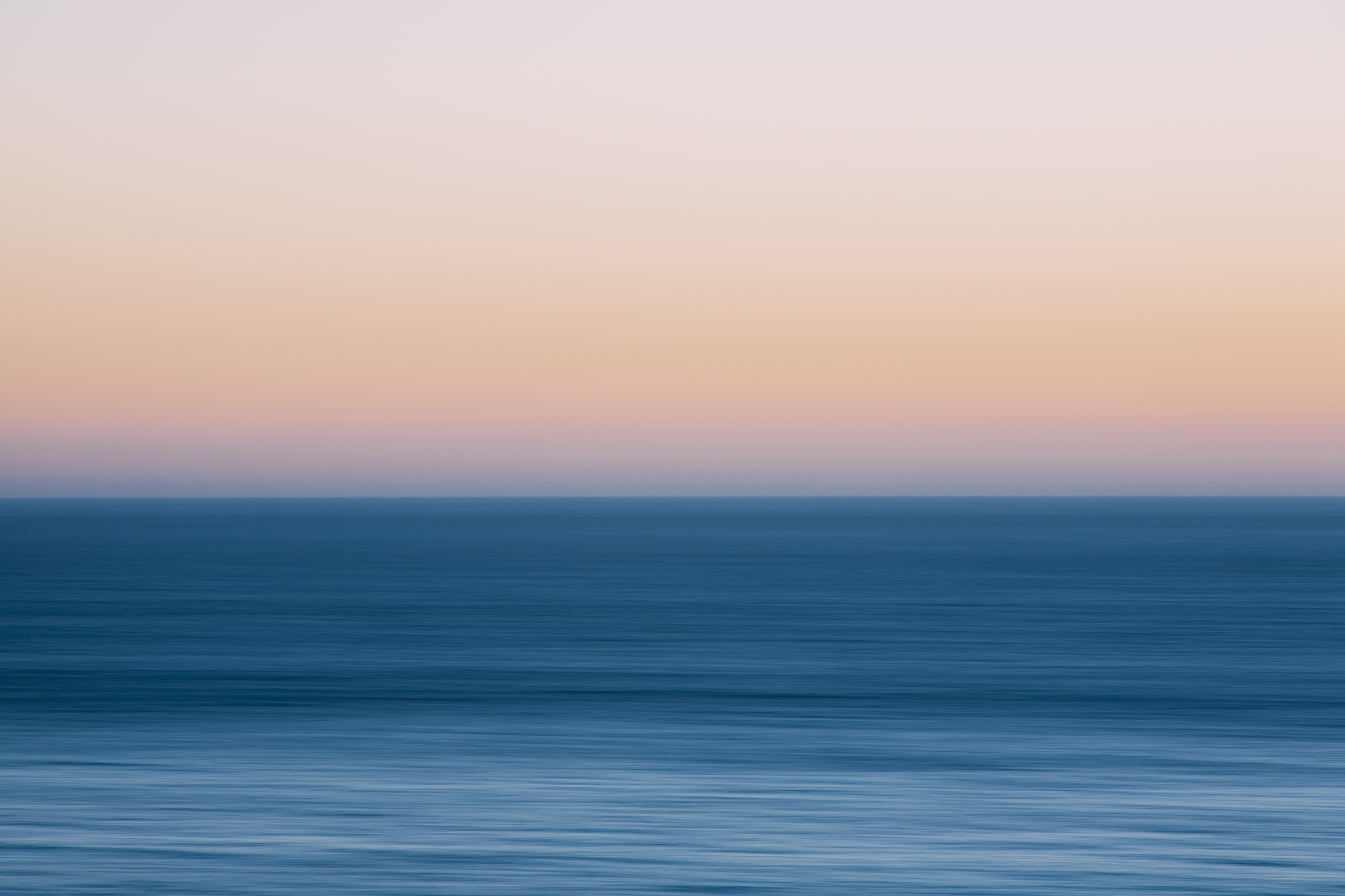 A view out to sea over the Pacific Ocean at dusk. Blurred motion.