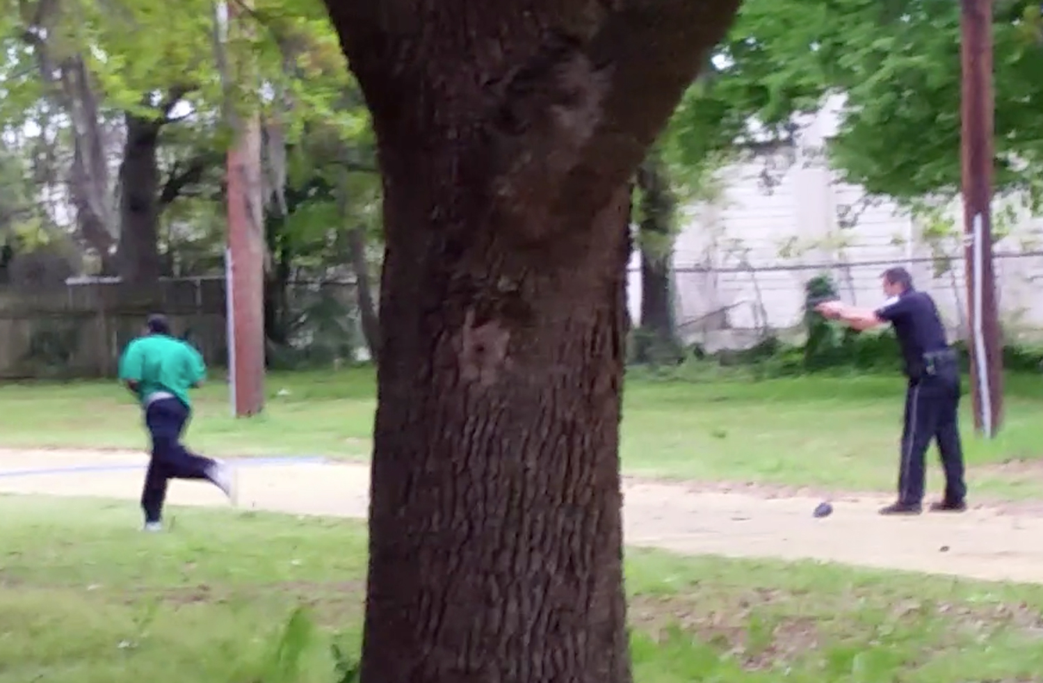 In this April 4, 2015, frame from video provided by Attorney L. Chris Stewart, Walter Scott runs away from city patrolman Michael T. Slager (R) in North Charleston, S.C.
