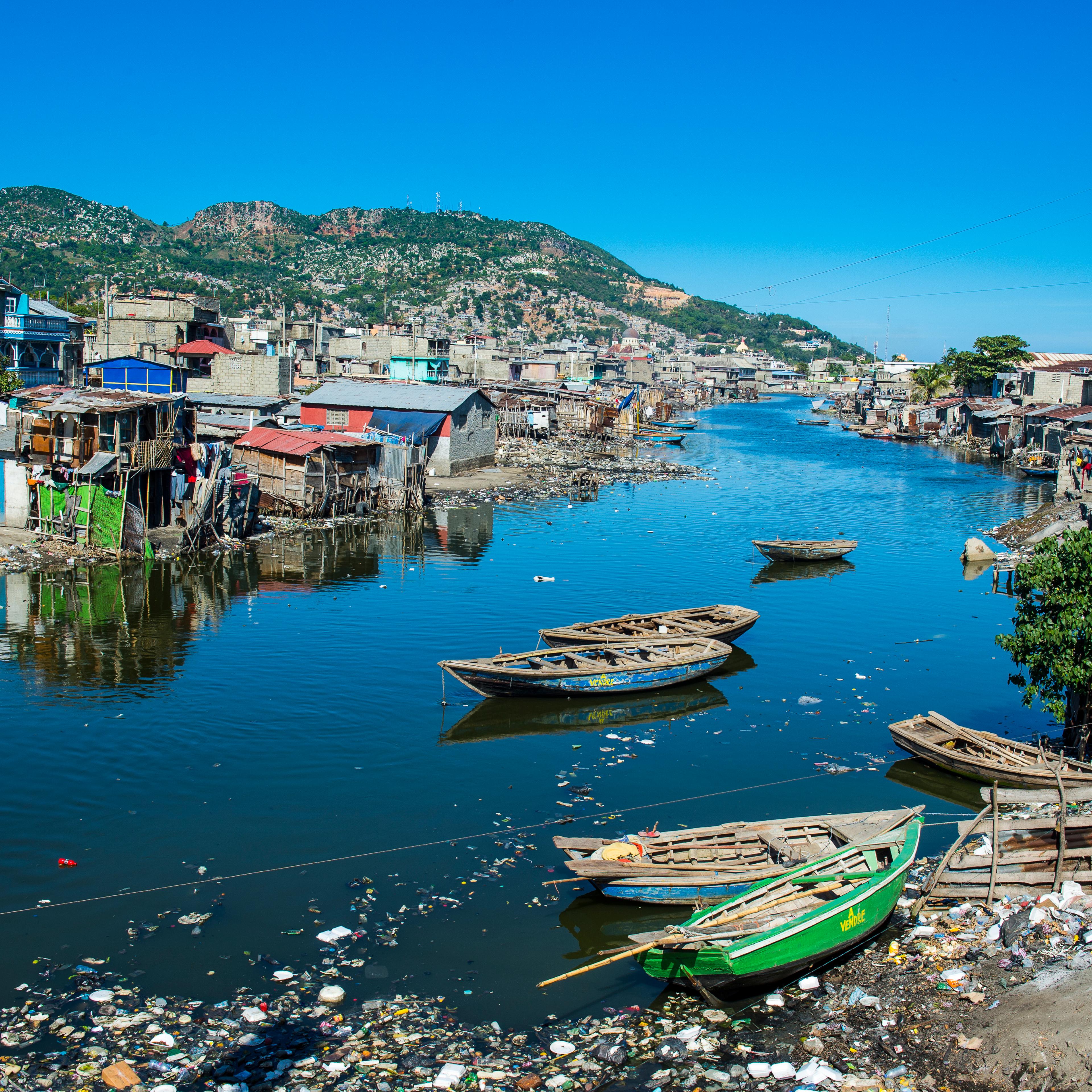 Totally polluted River Mapou flowing through Cap Haitien, Haiti, Caribbean, Central America