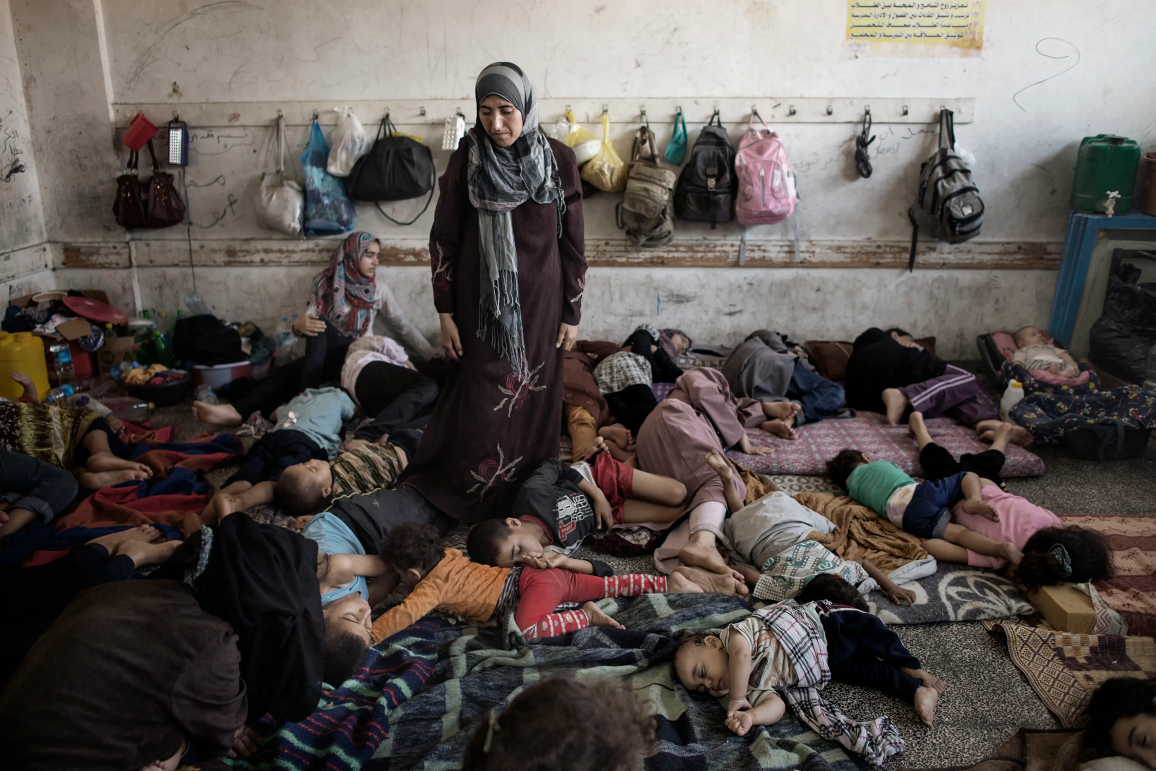 Displaced Palestinians from Beit Hanoun sleep inside the UNRWA school in Jabalia, July 23, 2014.
