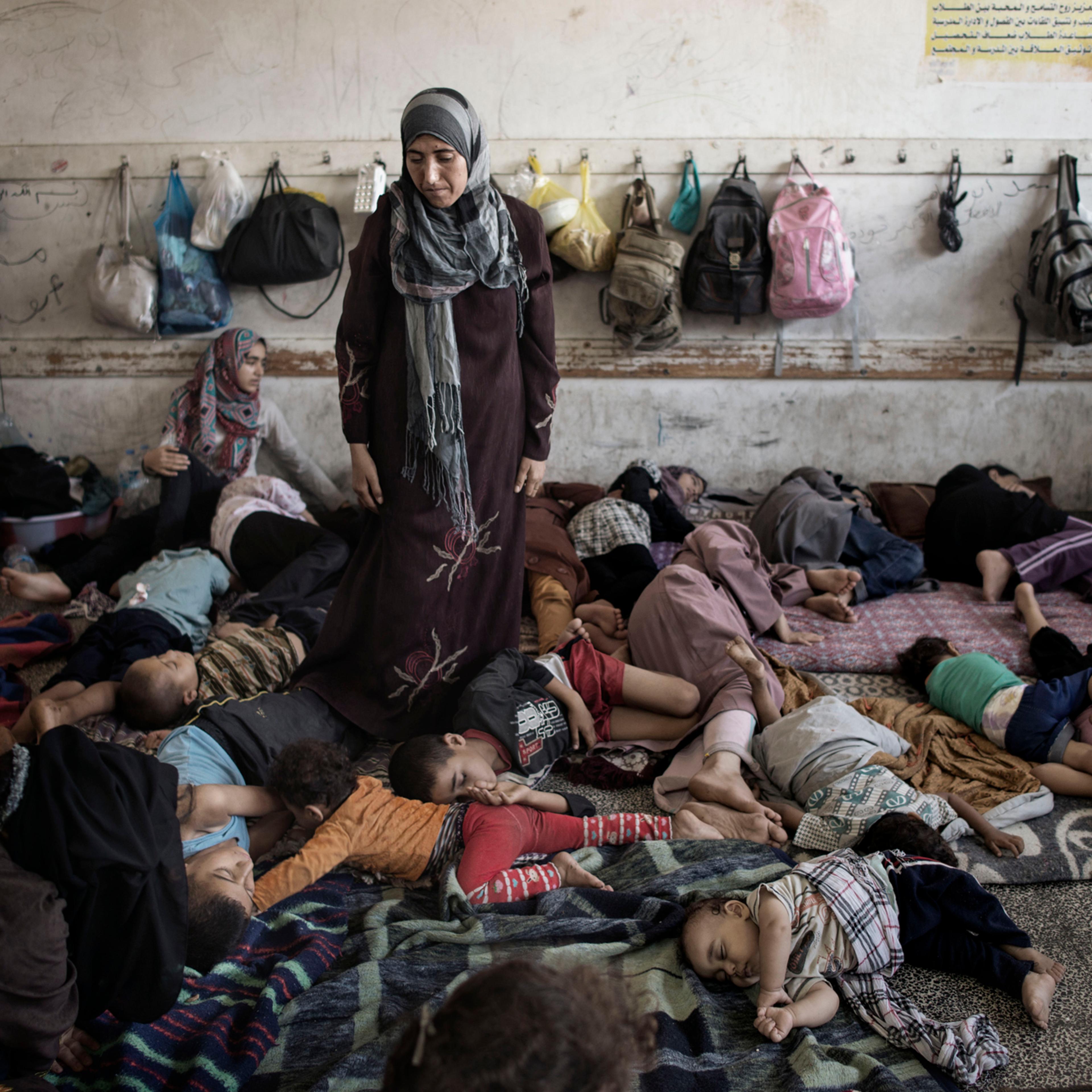 Displaced Palestinians from Beit Hanoun sleep inside the UNRWA school in Jabalia, July 23, 2014.