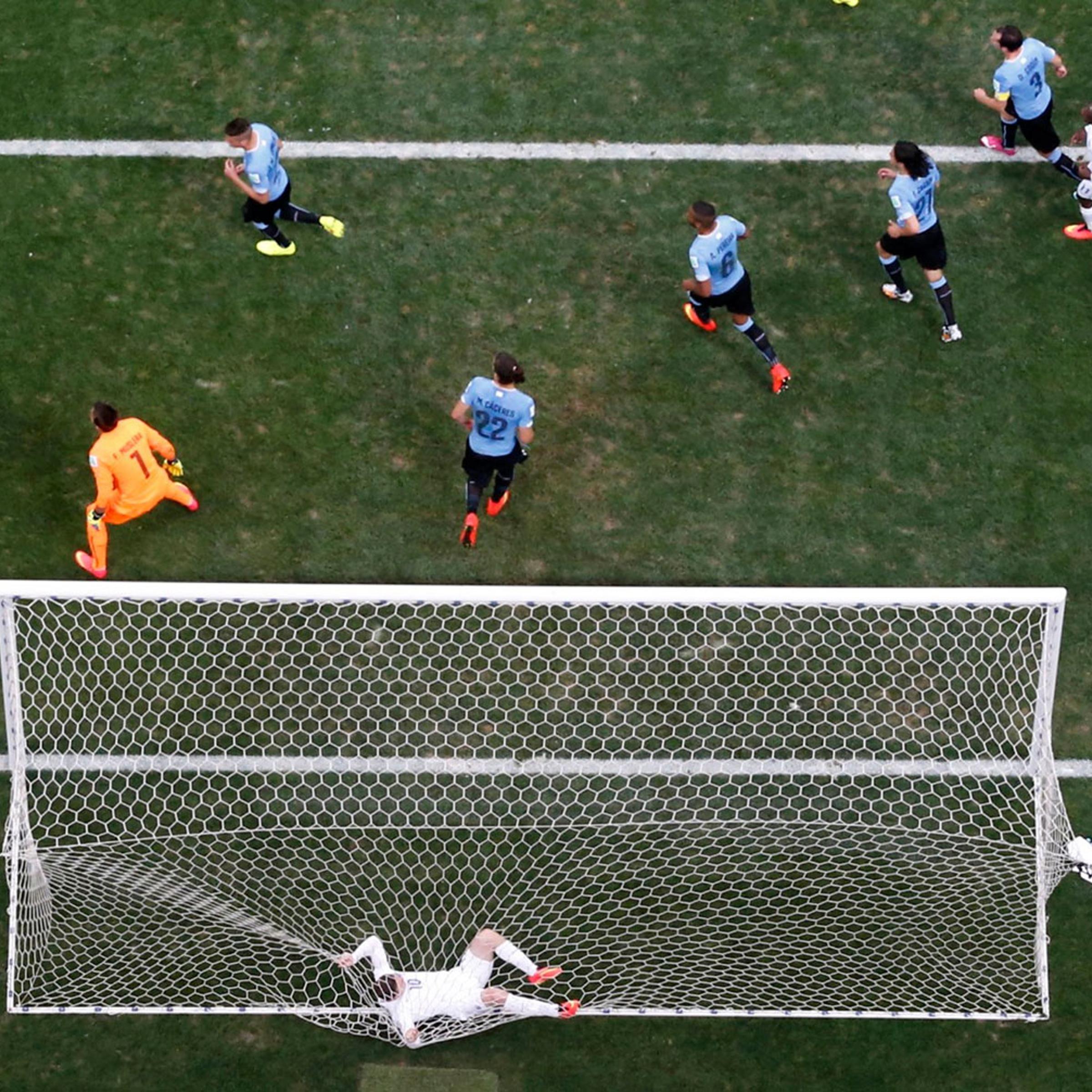 England's Wayne Rooney tangles himself in the net after failing to score a goal against Uruguay during their match at the Corinthians arena in Sao Paulo on June 19, 2014.
