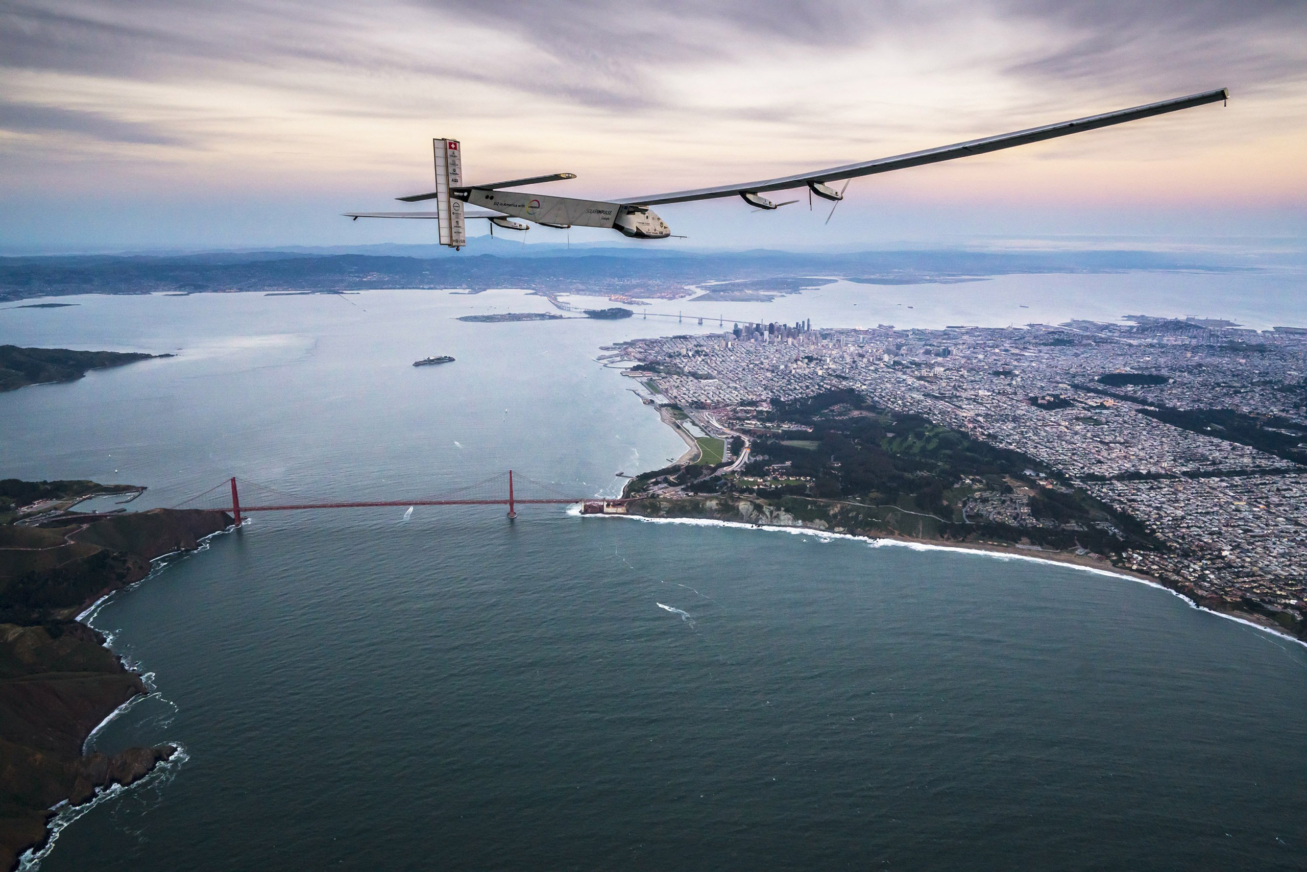 SAN FRANCISCO, CA - APRIL 23: In this handout image supplied by Jean Revillard, Solar powered plane 'Solar Impulse 2', piloted by Swiss adventurer Bertrand Piccard, flys over the Golden Gate bridge in San Francisco, after a flight from Hawaii during its 