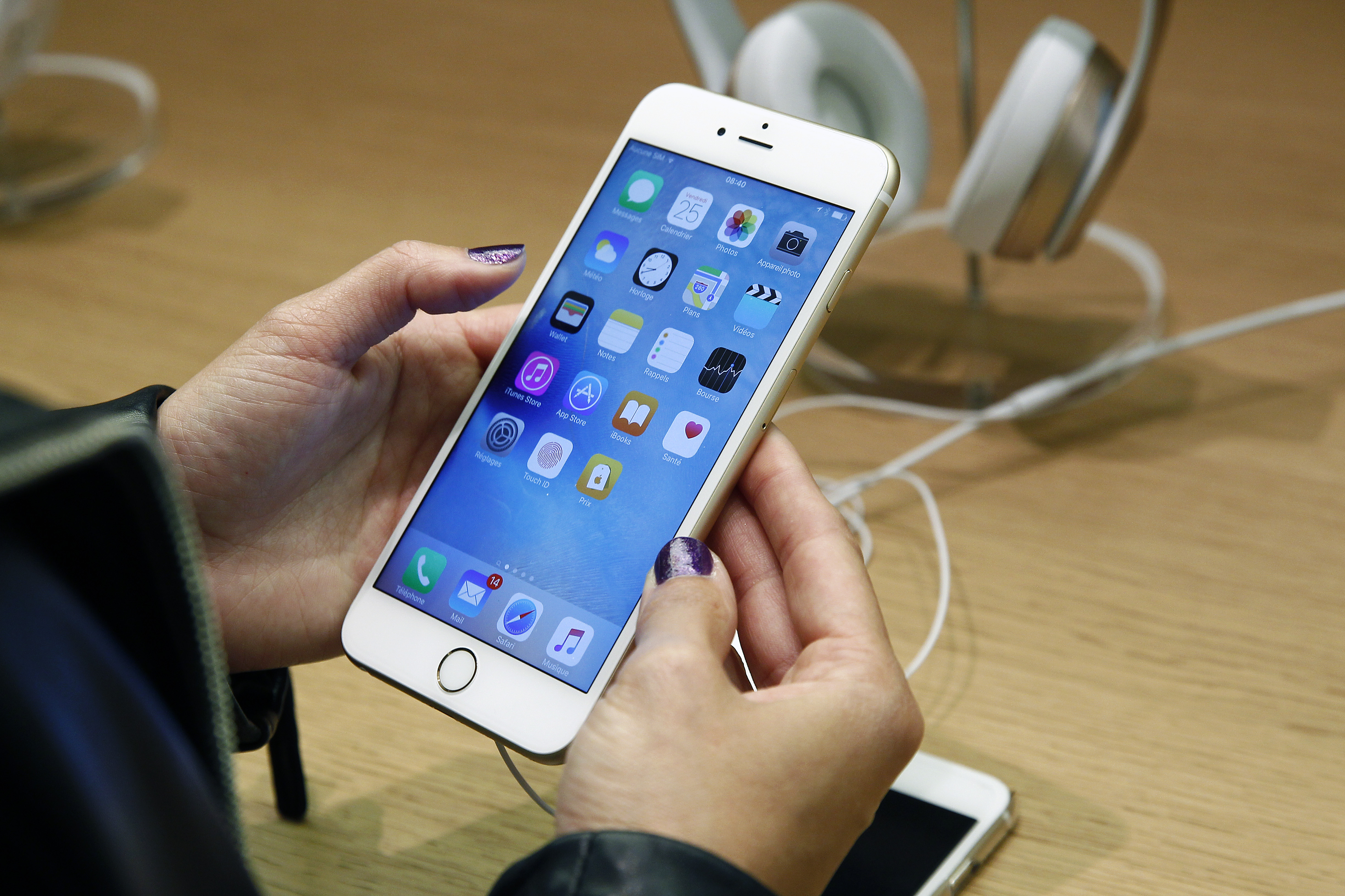 A customer checks the new iPhone 6s displayed at the Apple Store Opera on September 25, 2015 in Paris, France.