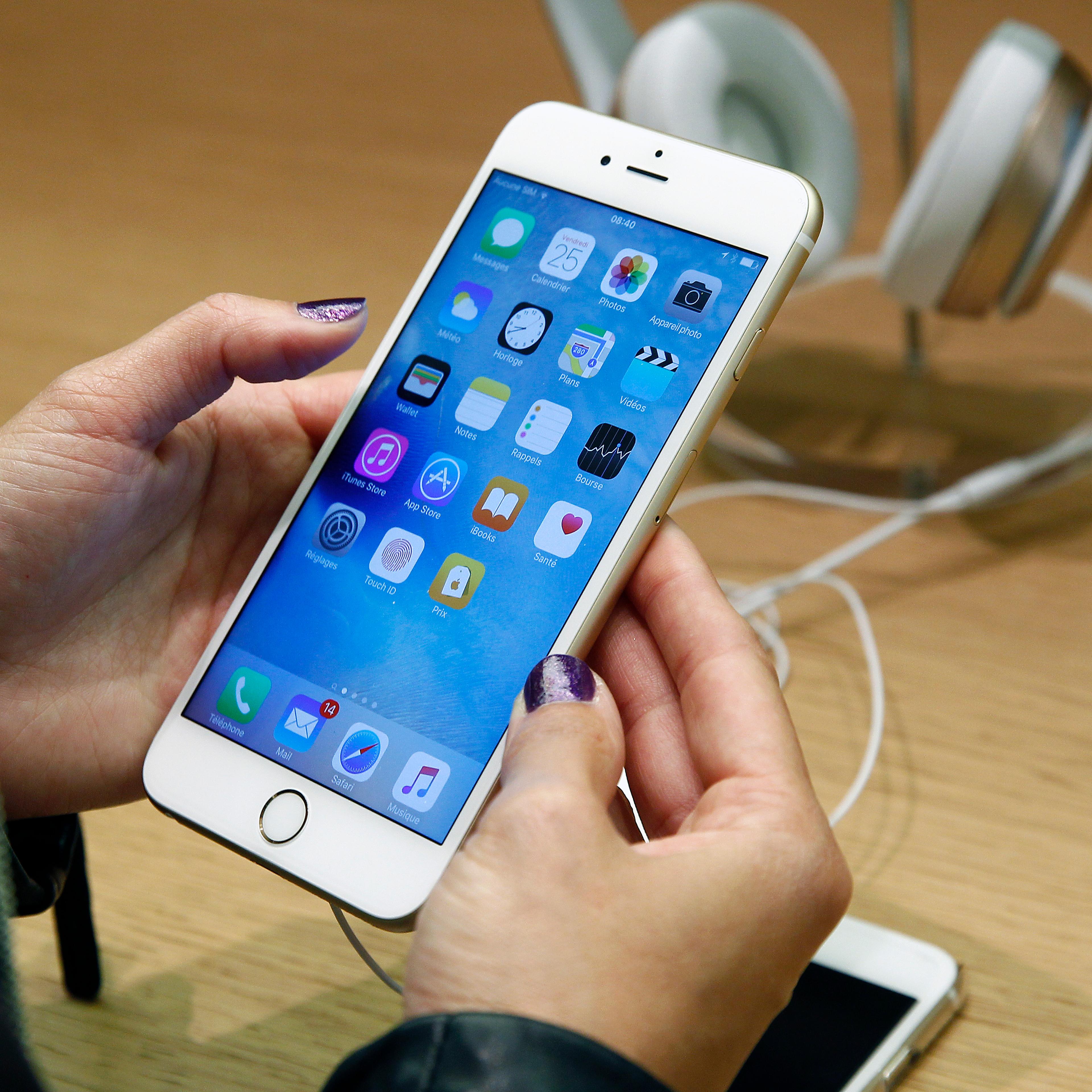 A customer checks the new iPhone 6s displayed at the Apple Store Opera on September 25, 2015 in Paris, France.