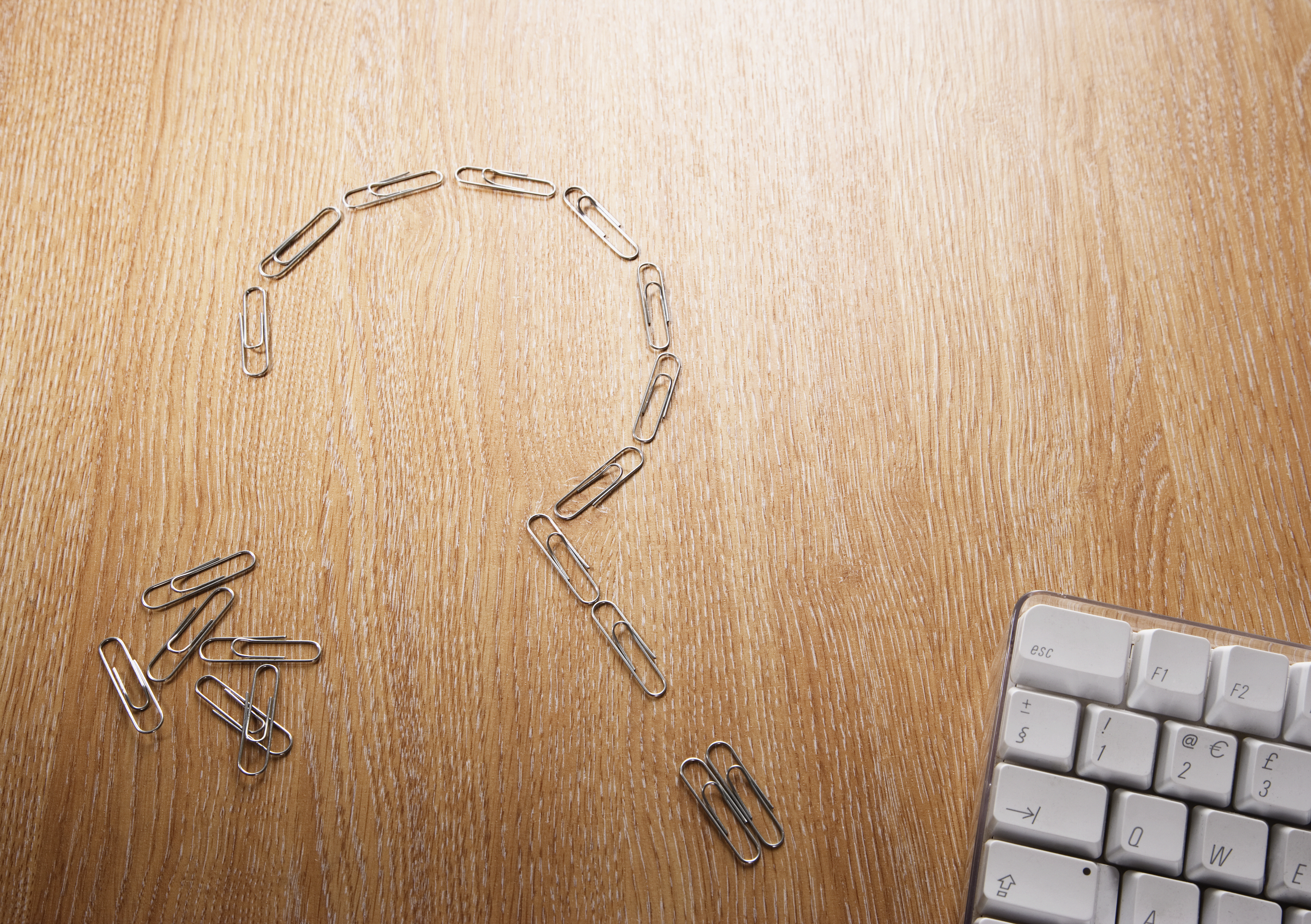 Close up of paperclips in shape of question mark