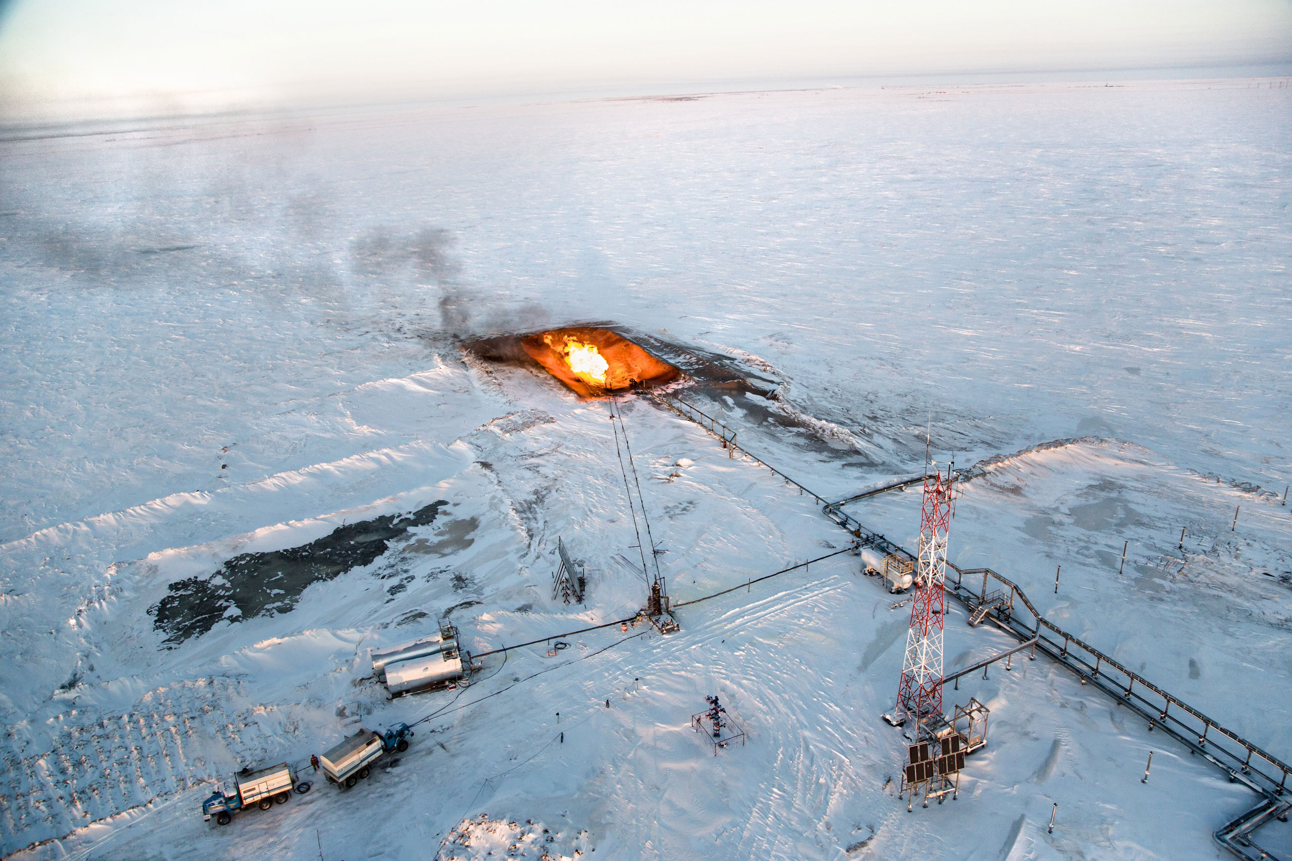 The flaring of gas is seen overhead at a drilling well in Novy Urengoi, Arctic Siberia, Russia, December 2014.