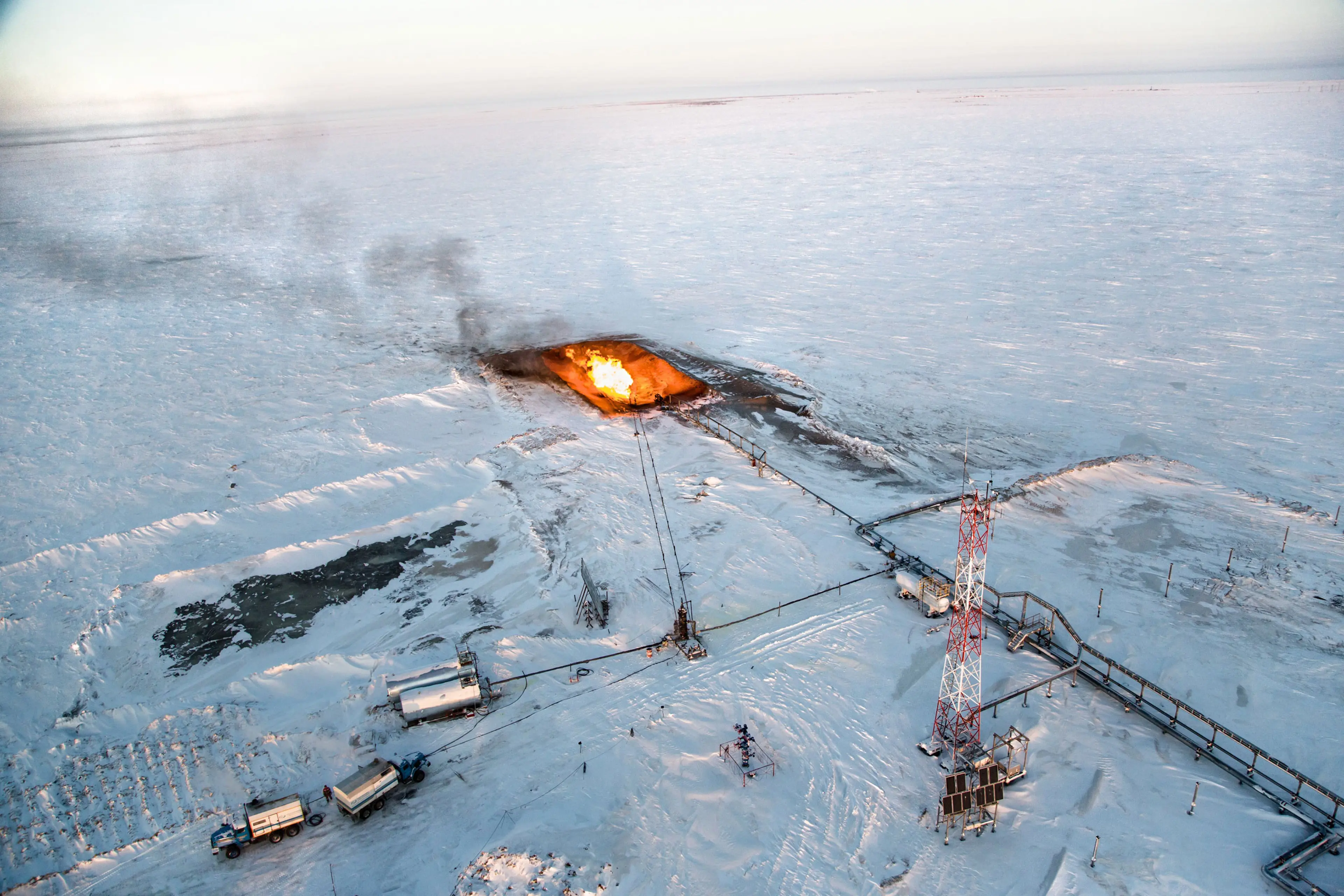 The flaring of gas is seen overhead at a drilling well in Novy Urengoi, Arctic Siberia, Russia, December 2014.