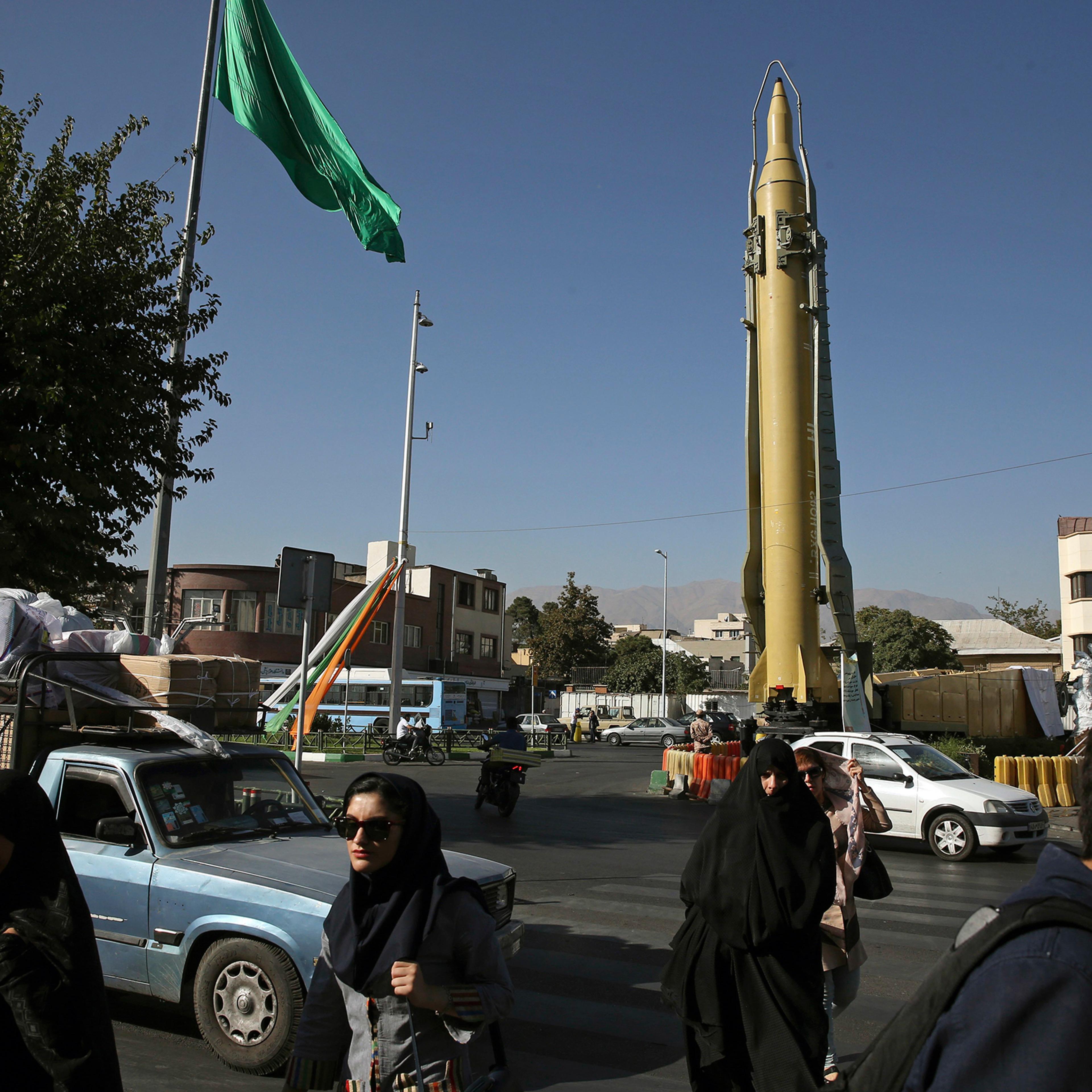 Iranians walk past a Ghadr-F missile displayed at a Revolutionary Guard hardware exhibition, marking 36th anniversary of the outset of Iran-Iraq war, in downtown Tehran on Sept. 25, 2016.
