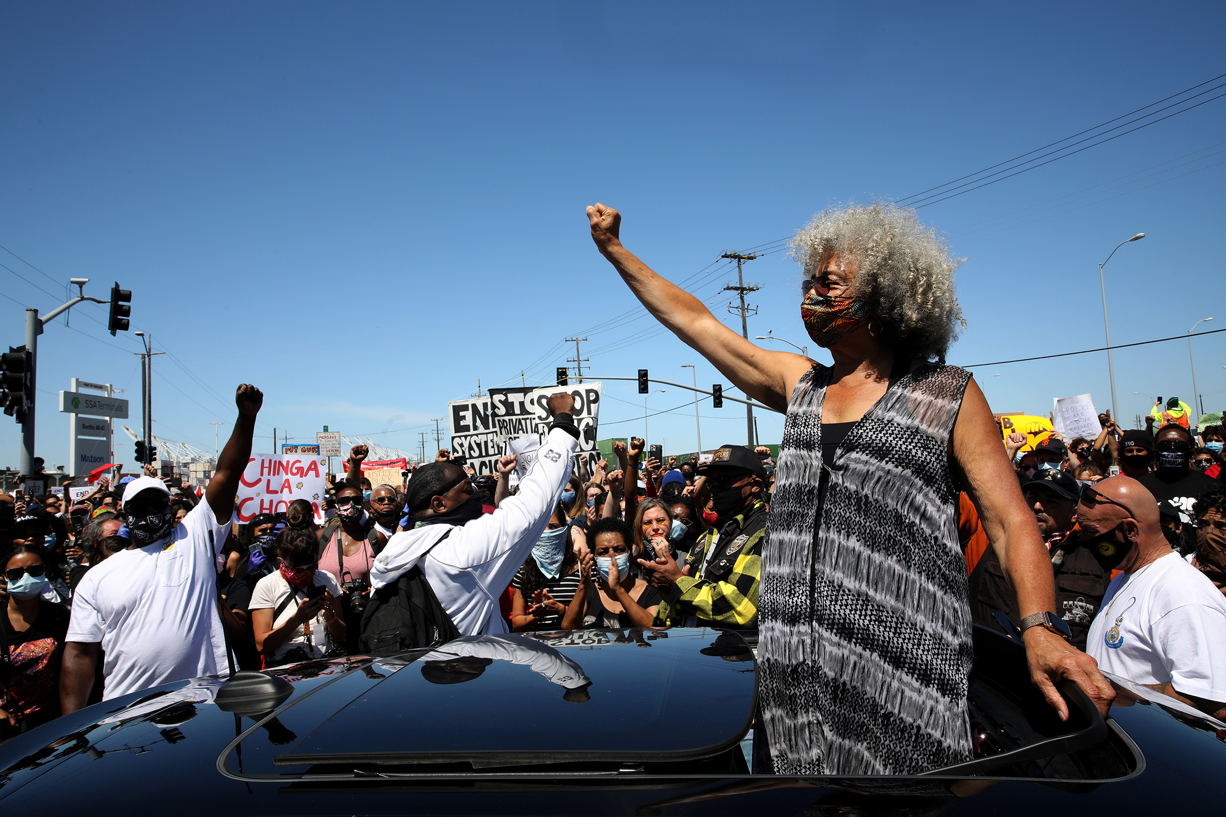 Civil rights leader Angela Davis raises her fist during a Juneteenth protest against police brutality in Oakland, Calif., on June 19, 2020.