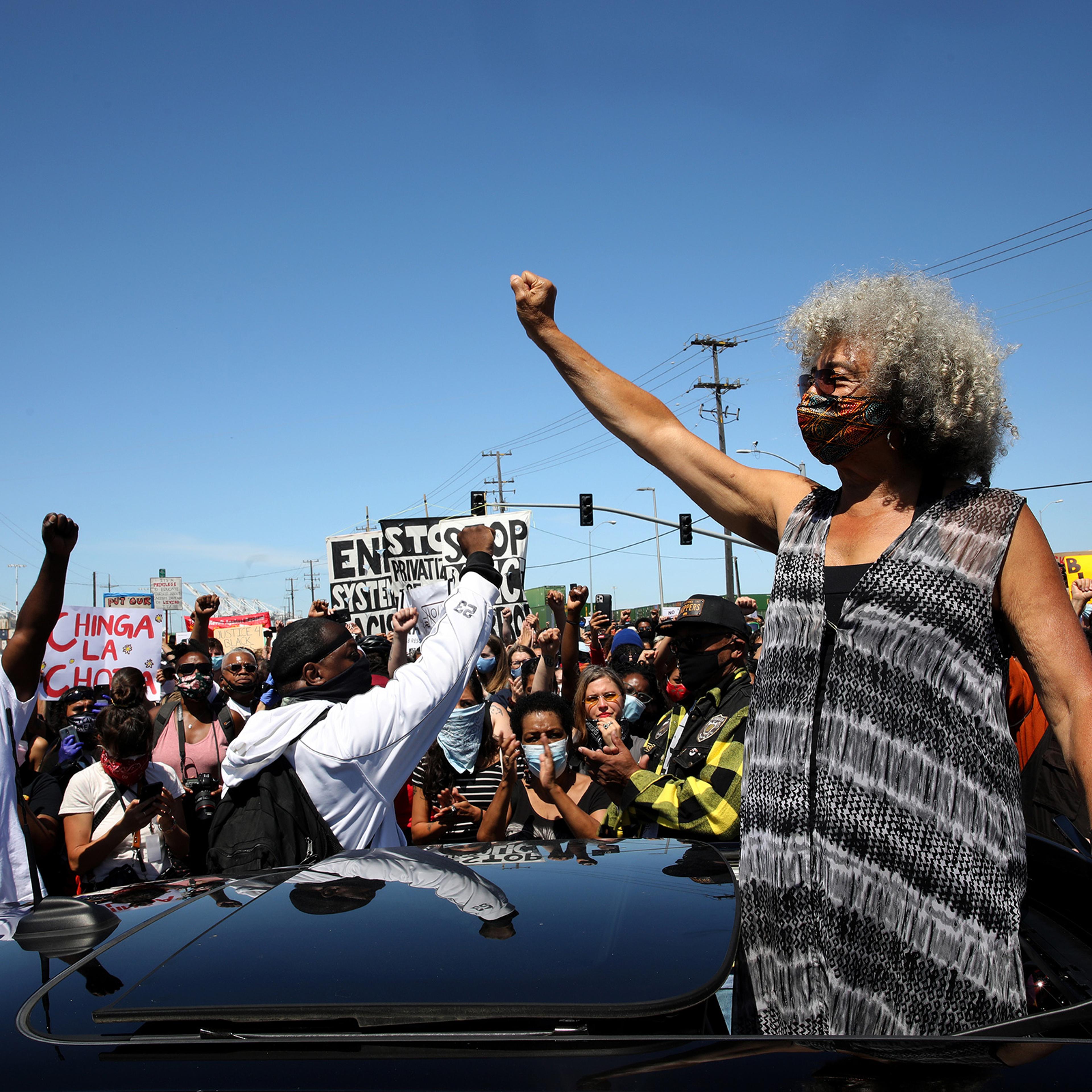 Civil rights leader Angela Davis raises her fist during a Juneteenth protest against police brutality in Oakland, Calif., on June 19, 2020.