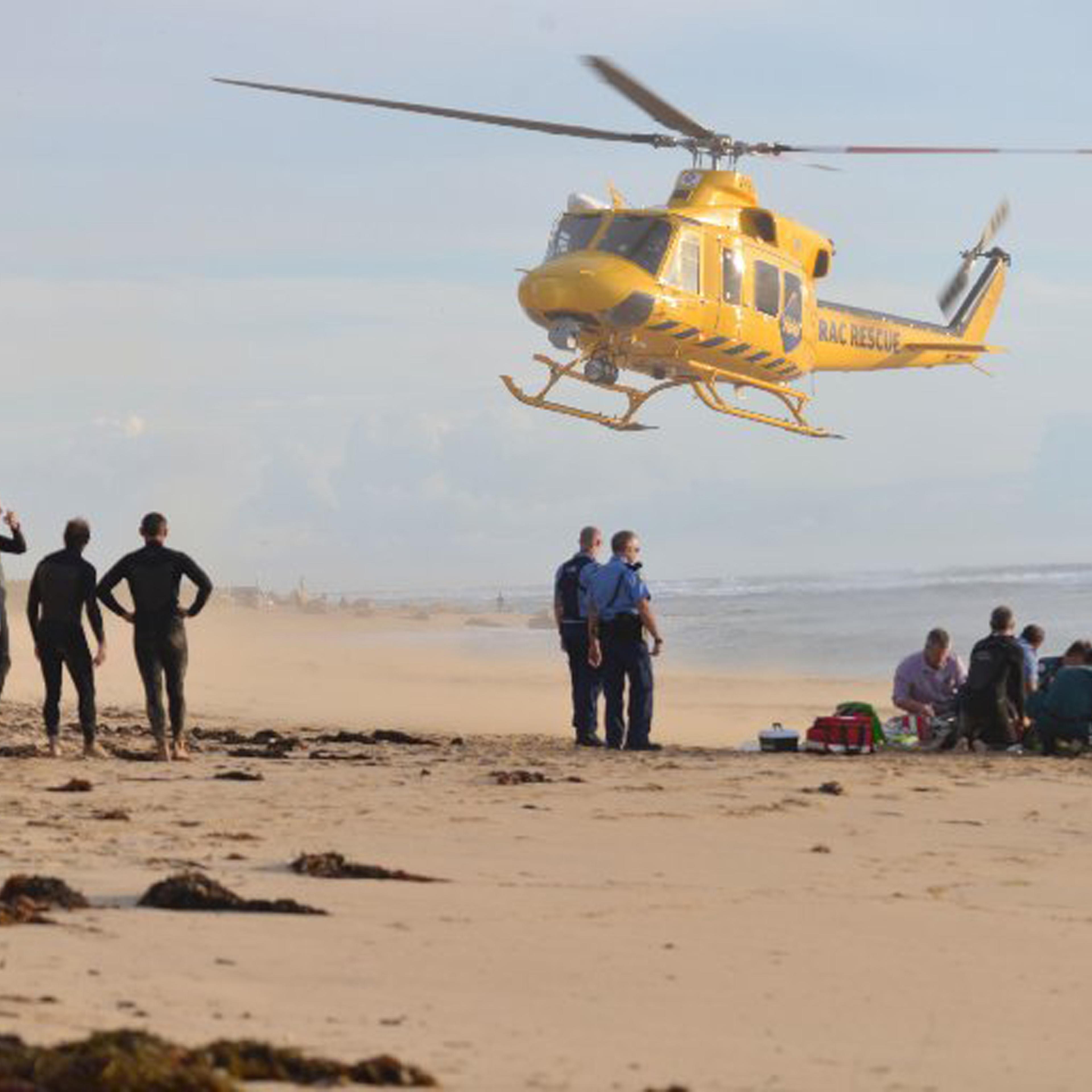 A photo taken on 31 May, 2016, shows a rescue helicopter arriving to transport a critically injured surfer after a shark ripped off his leg in an attack in Australia's west with witnesses recounting how "all hell broke loose" as his board was snapped in