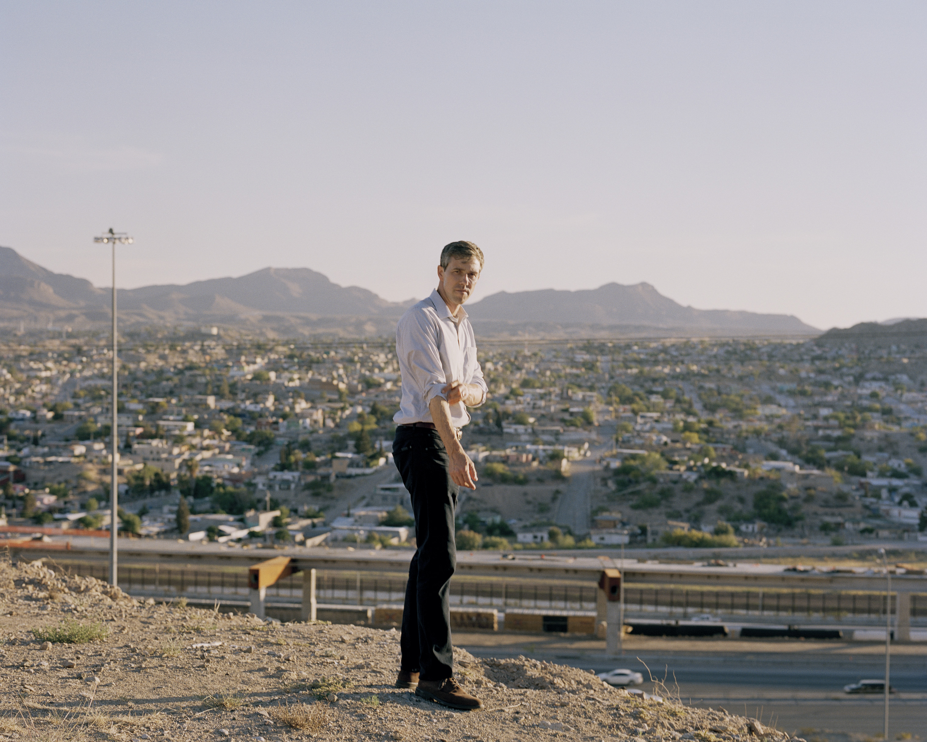Beto O'Rourke stands with the border between El Paso and Juarez behind him