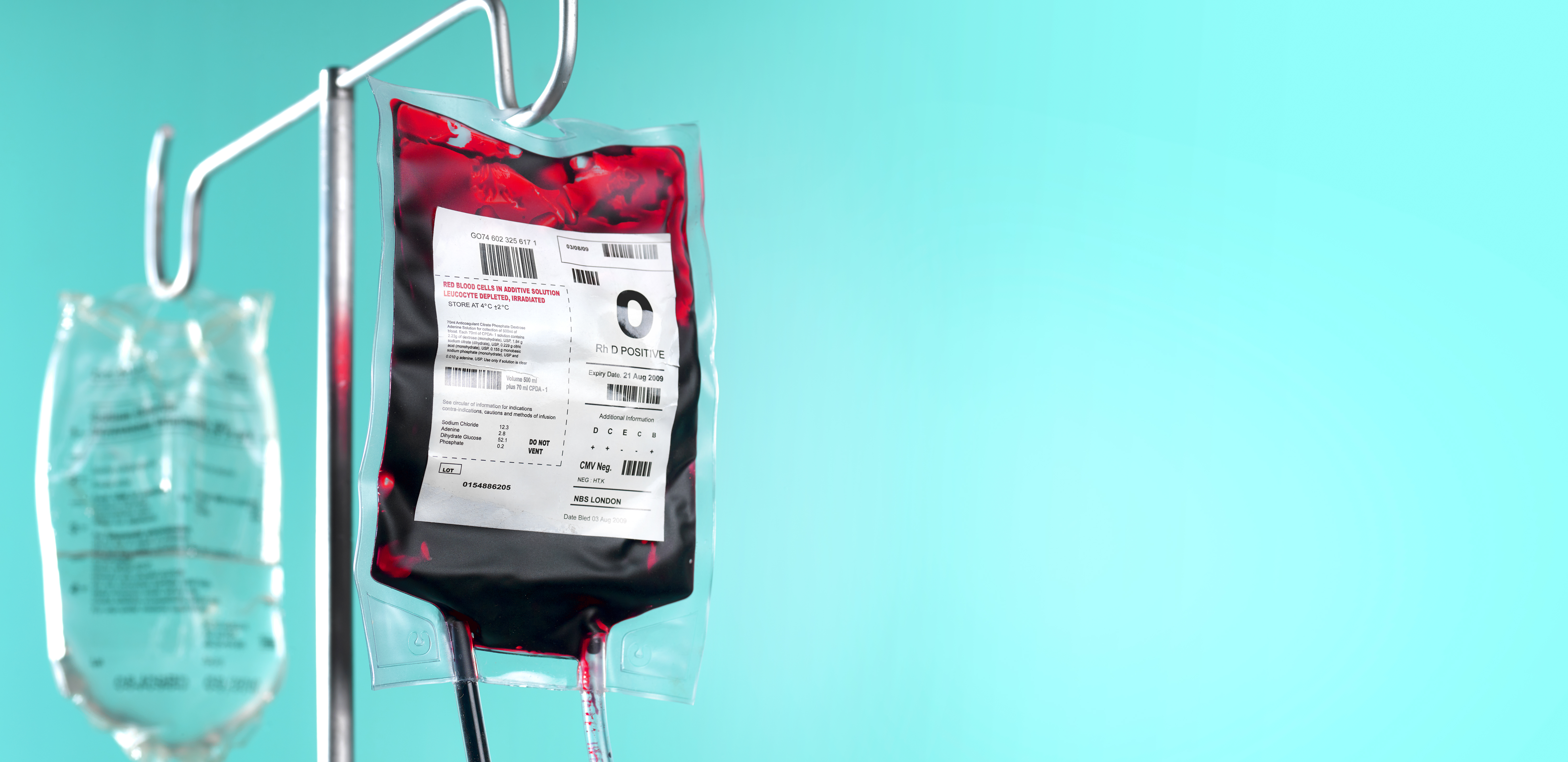IV blood bag and saline drip on hospital stand with copy space