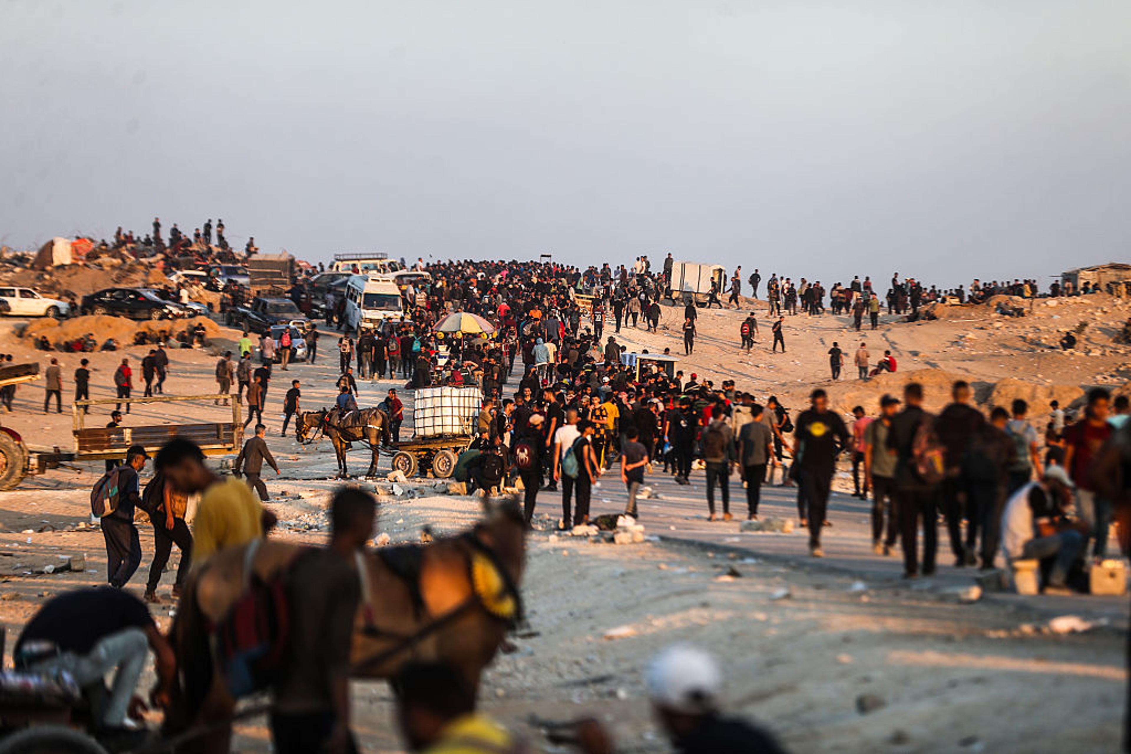 Palestinians gather around central Gaza, awaiting for aid to enter from a non-GHF distribution site on July 2.