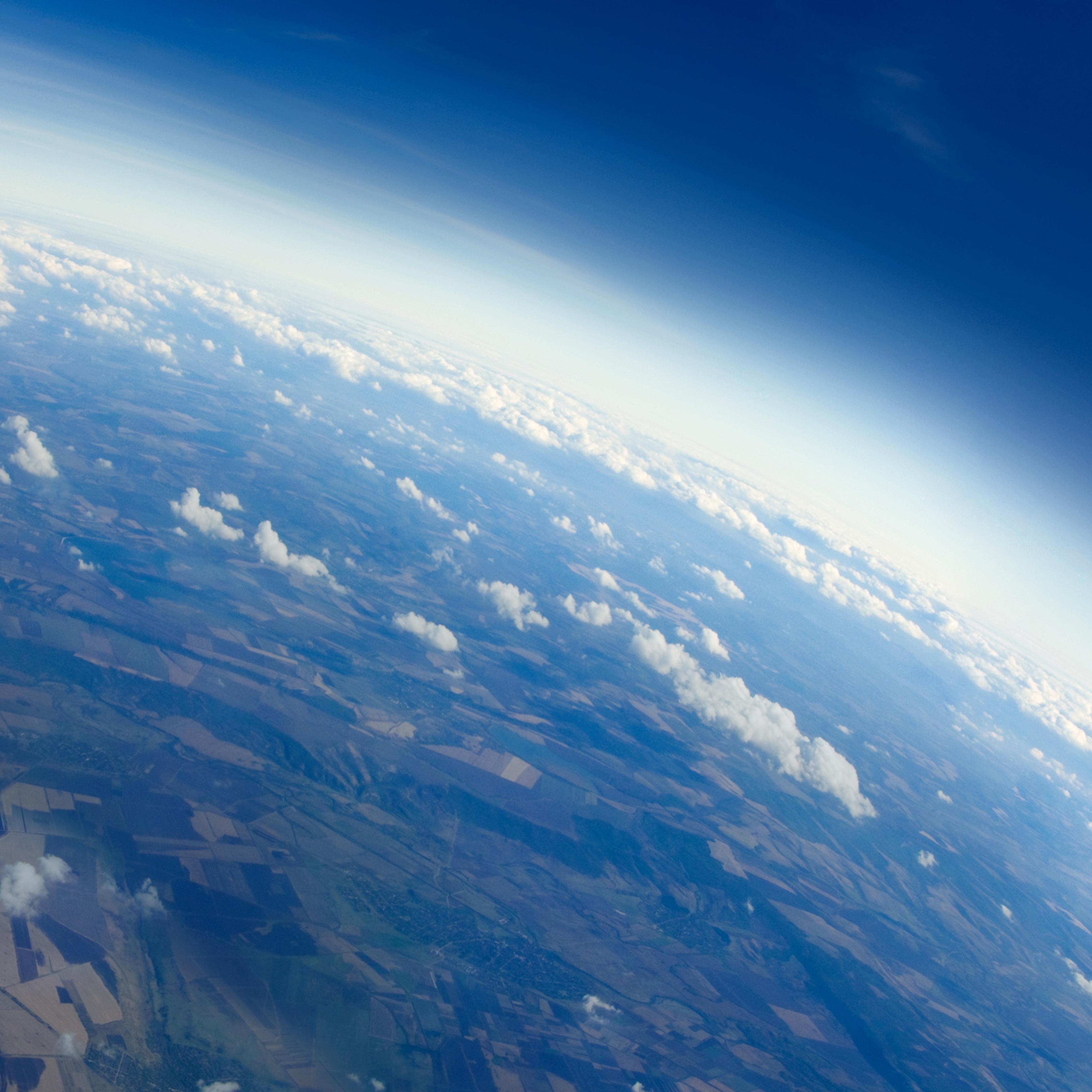 Aerial view of earth with clouds and the horizon.