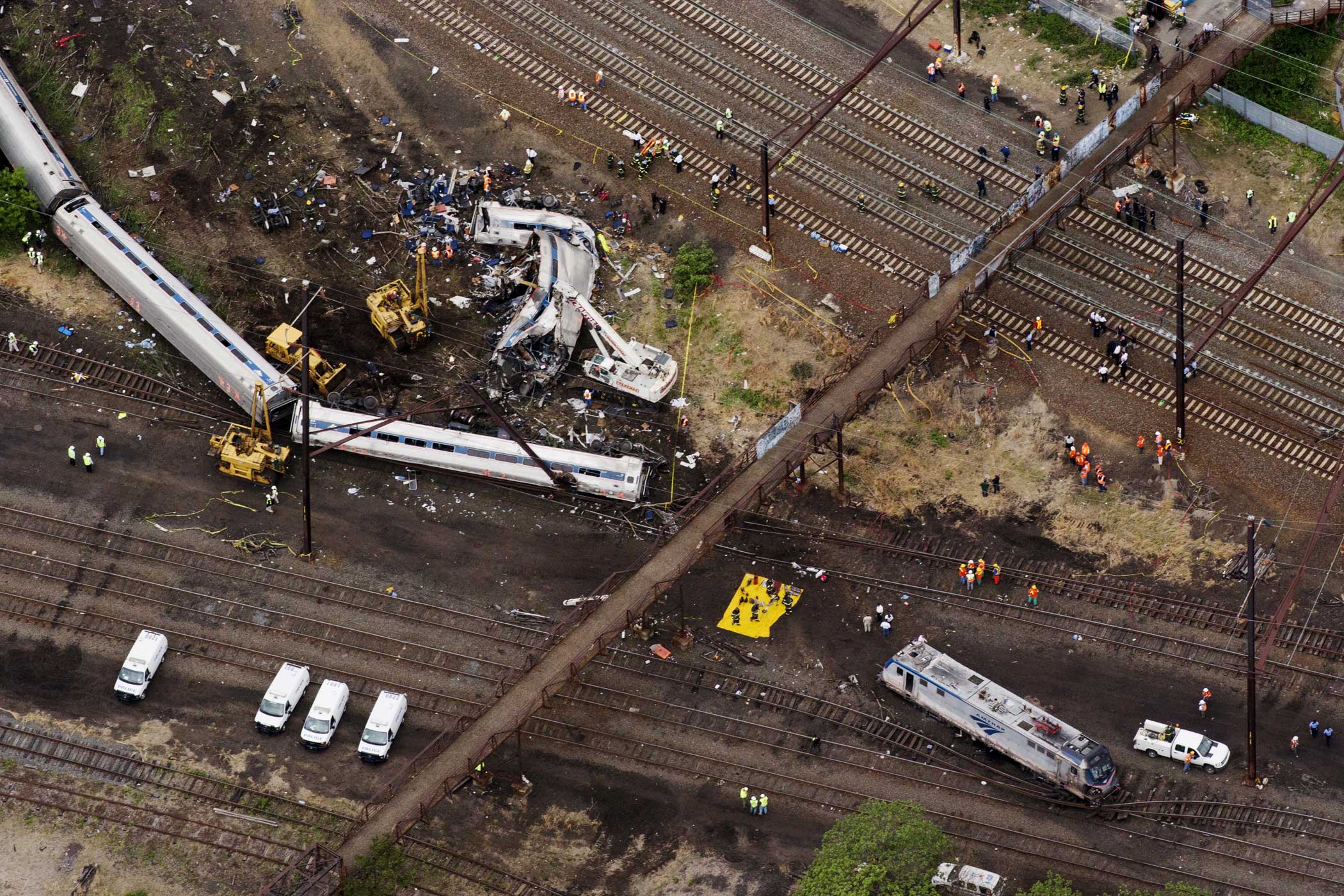 Emergency workers look through the remains of a derailed Amtrak train in Philadelphia on May 13, 2015.