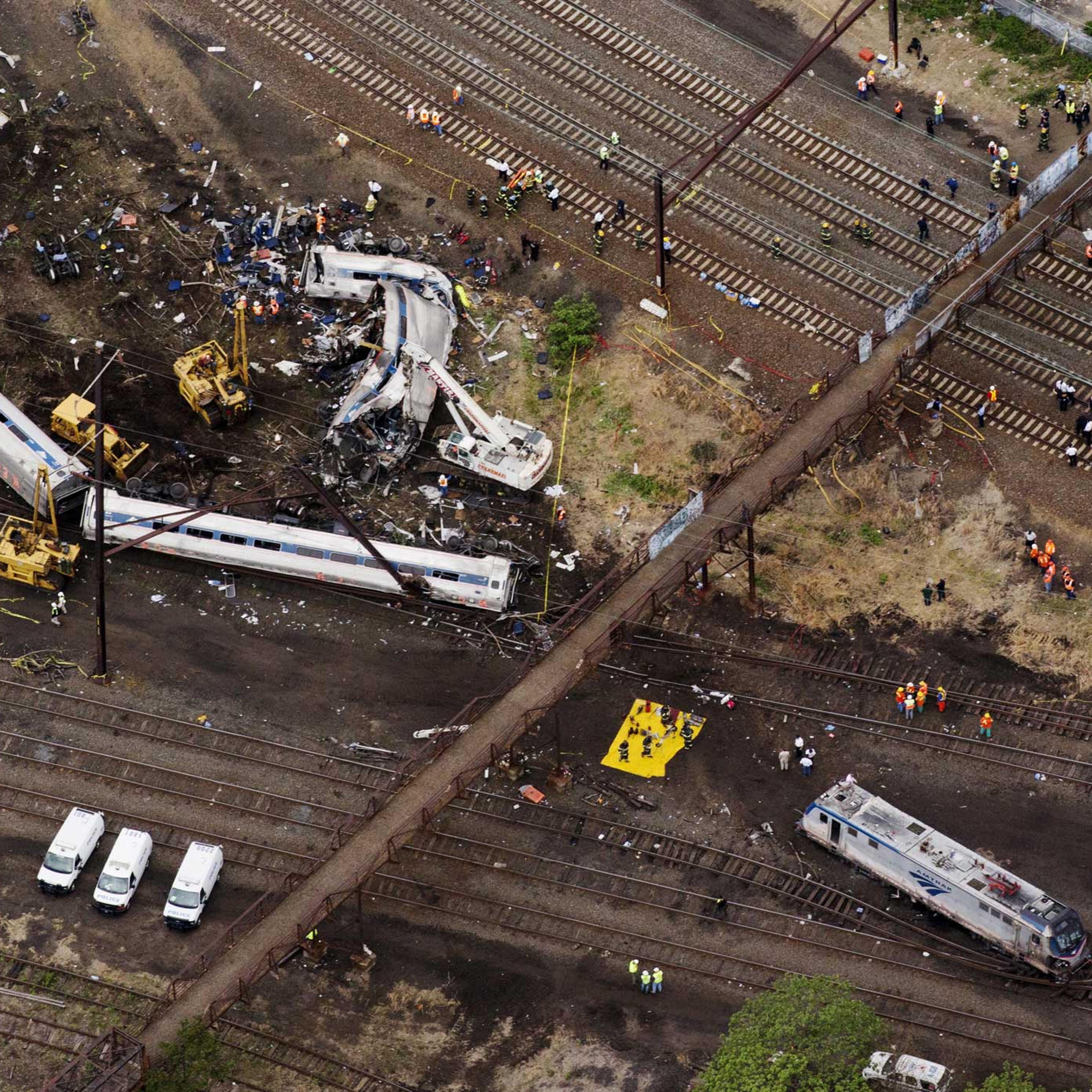 Emergency workers look through the remains of a derailed Amtrak train in Philadelphia on May 13, 2015.