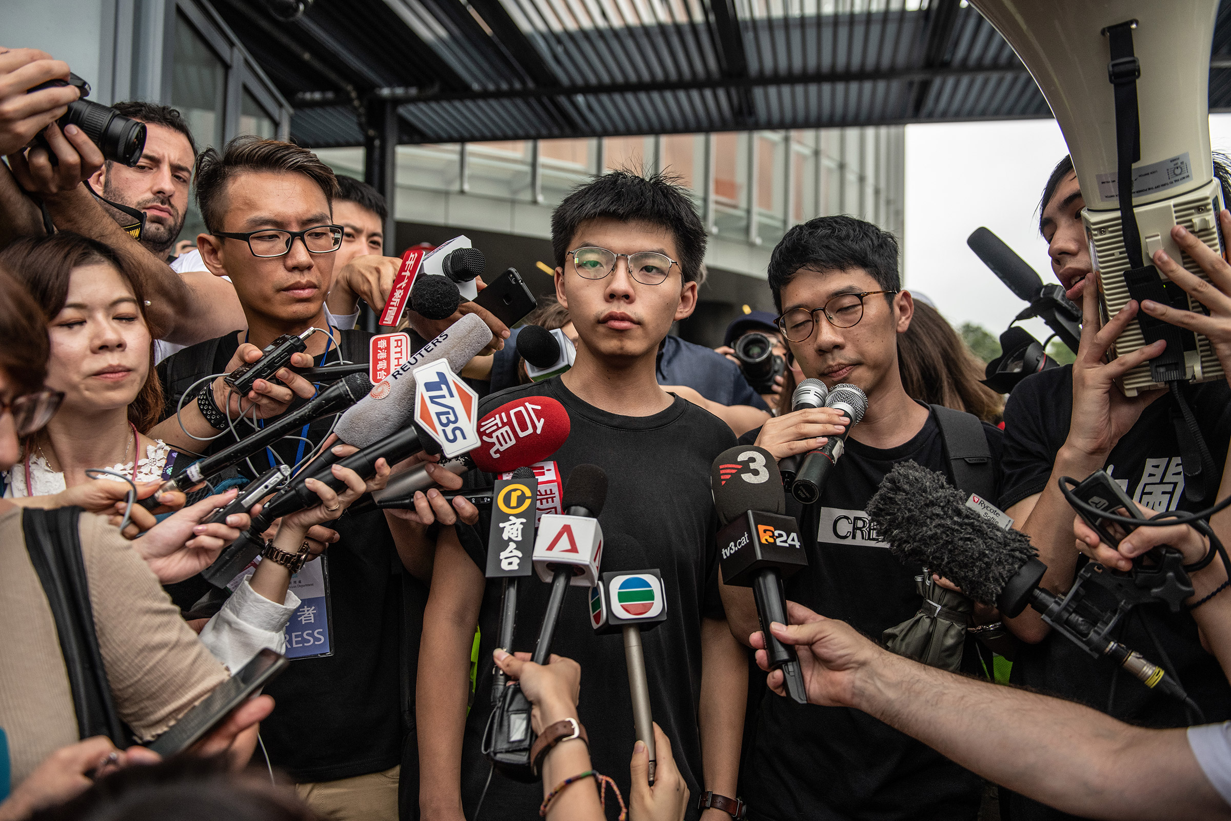 Pro-democracy activist Joshua Wong speaks to the media outside the Legislative Council