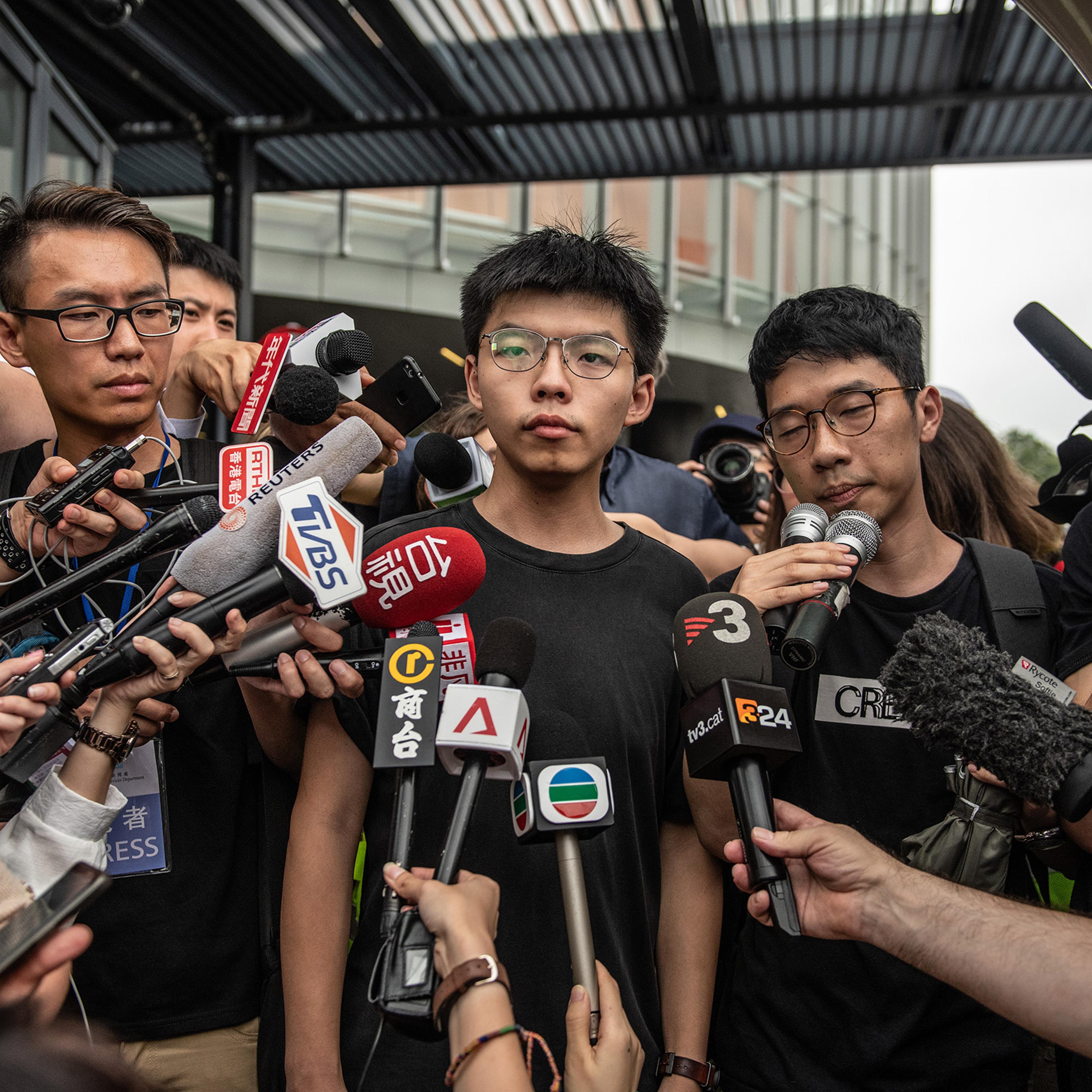 Pro-democracy activist Joshua Wong speaks to the media outside the Legislative Council