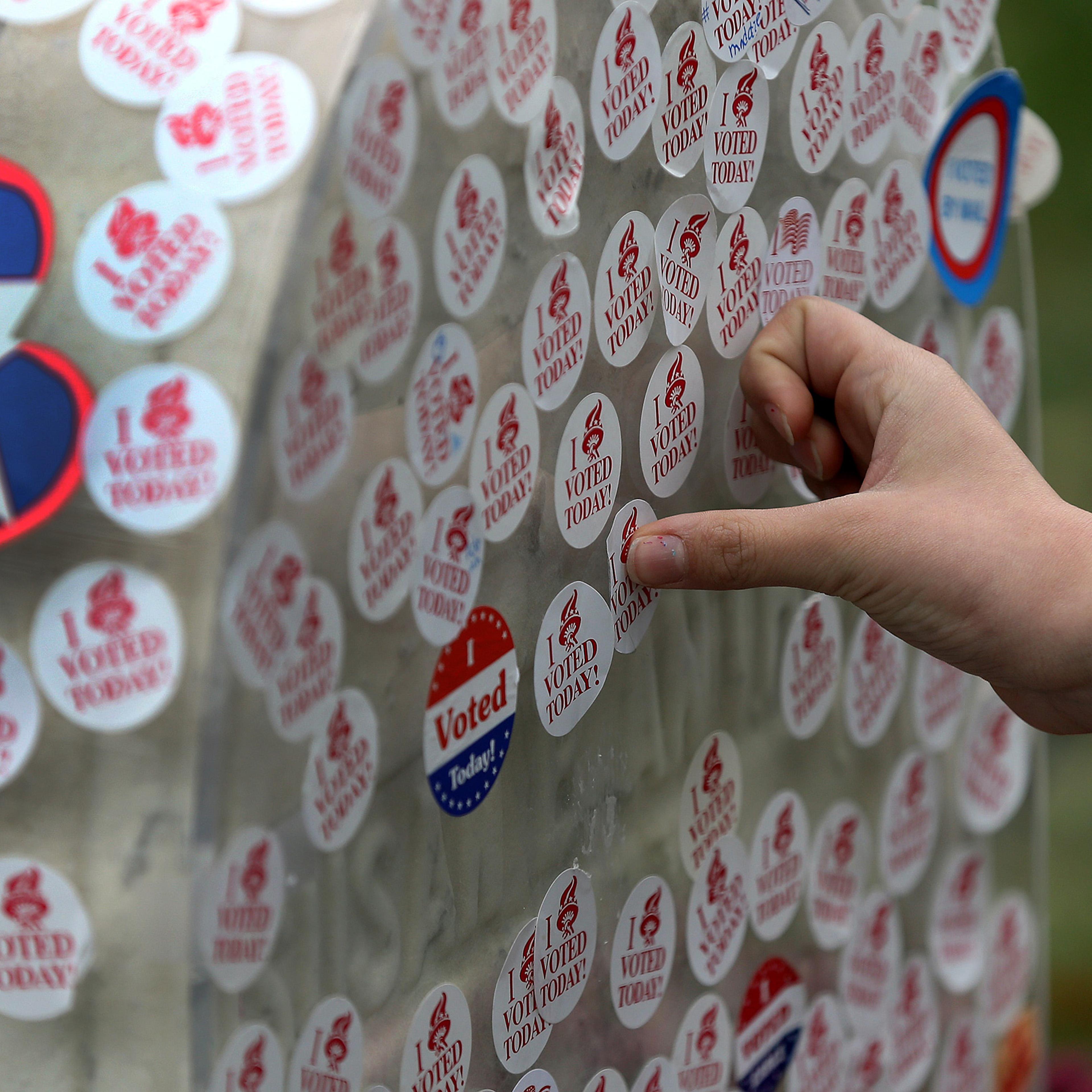 In an Election Day tradition, visitors place their "I Voted" stickers on the gravestone of Susan B. Anthony