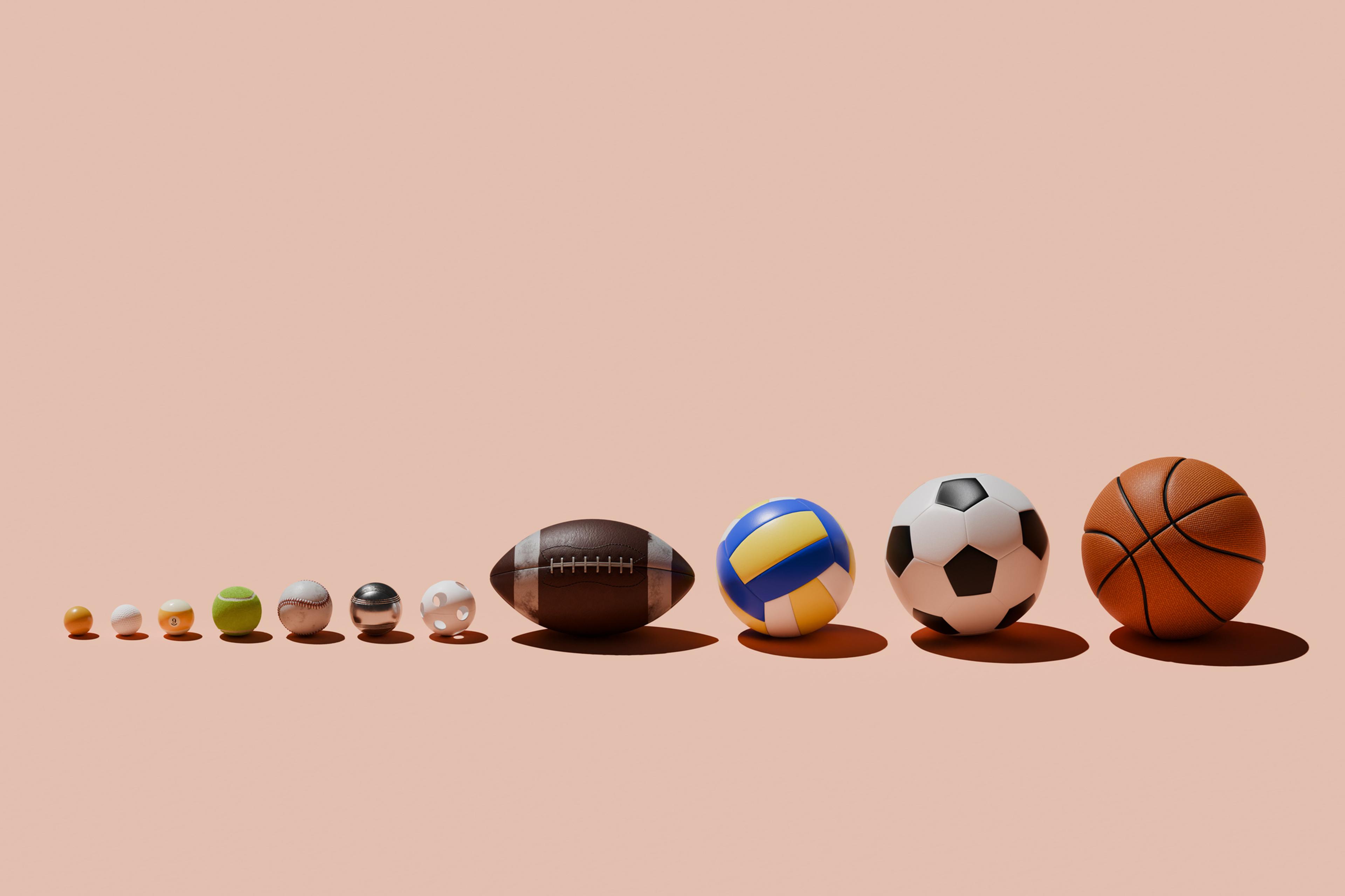 Various sports balls in a row