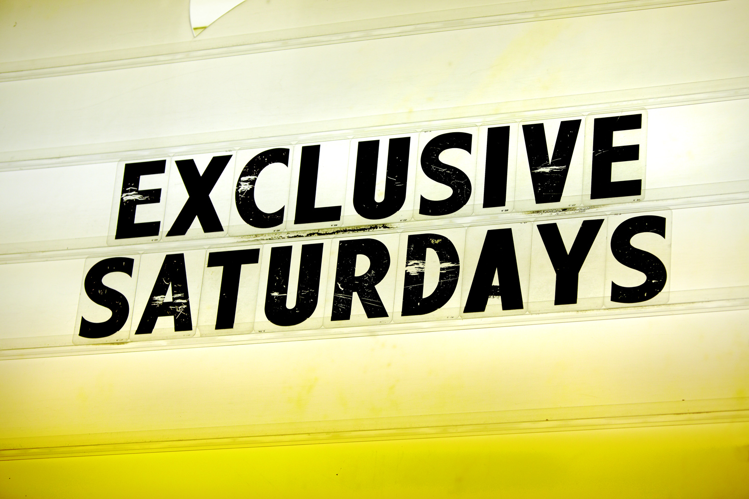 A sign outside of a club reads: Exclusive Saturdays, Two Dollar Tuesdays, Magic City Mondays, Bitch Slap Thursdays, Thirsty Thursdays, Pin Up Sundays.
