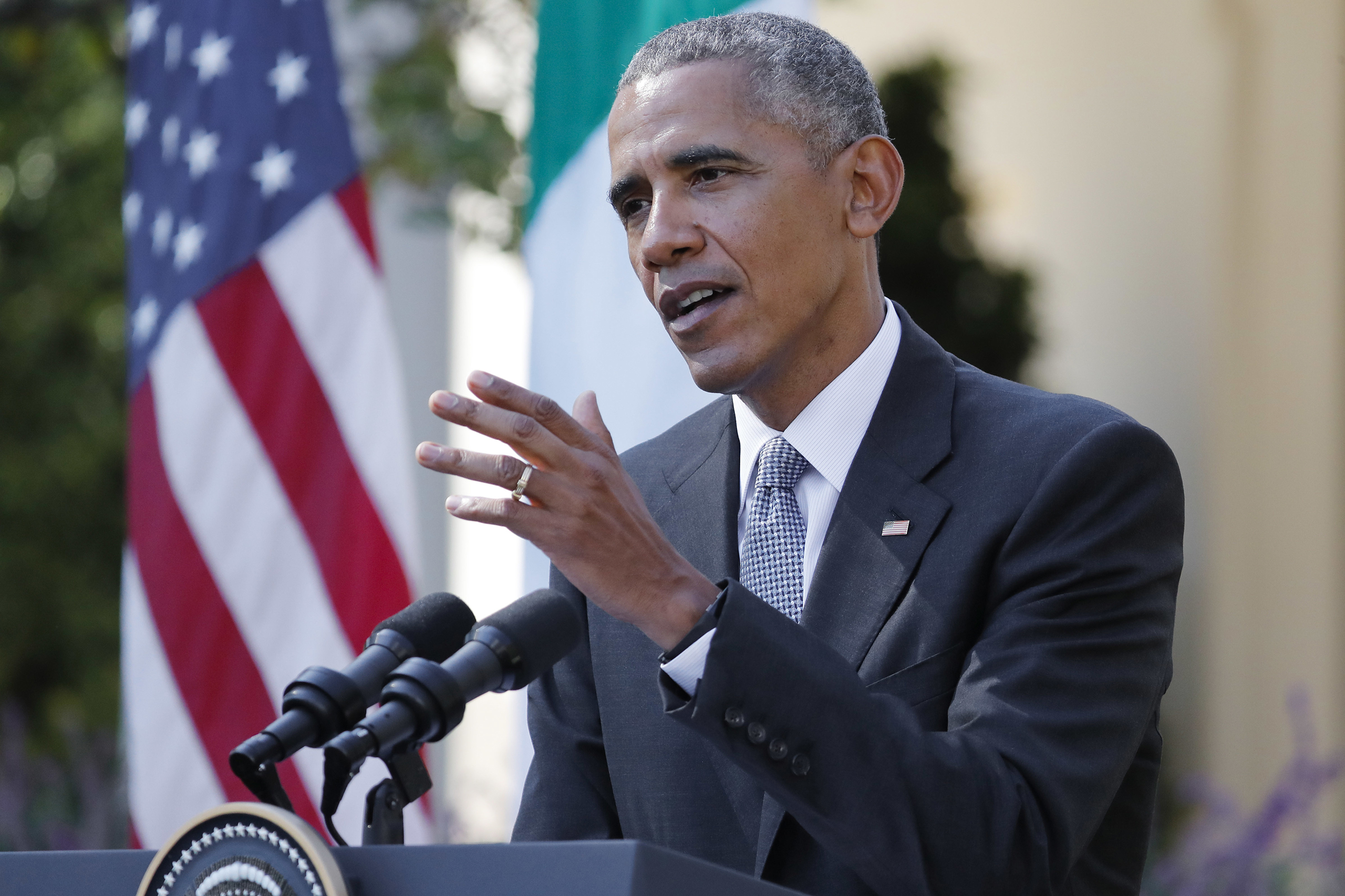Barack Obama answers a question during a joint news conference with Italian Prime Minister Matteo Renzi in the Rose Garden of the White House in Washington, Oct. 18, 2016.