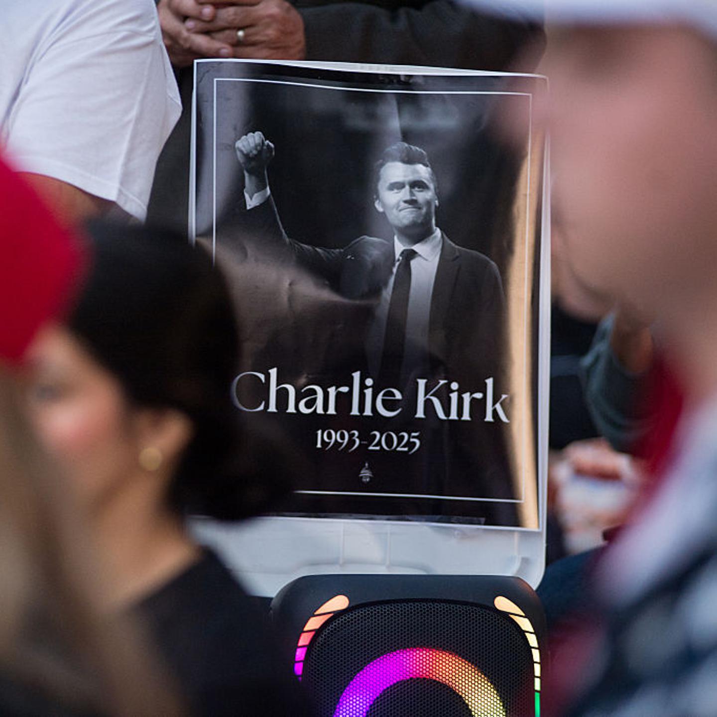 Residents of Lemont, Illinois, come together in a serene park setting to pay tribute to Charlie Kirk during a vigil on September 11, 2025.