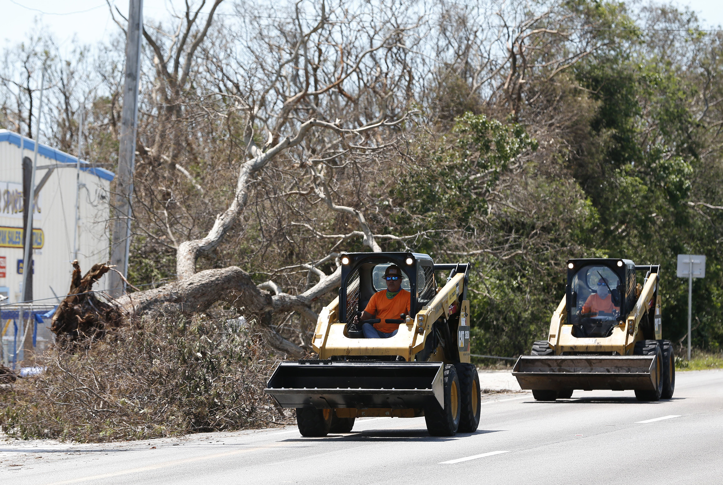 Workers prepare to remove debris, in Key Largo, Fla., in the Florida Keys, Sept. 12, 2017.