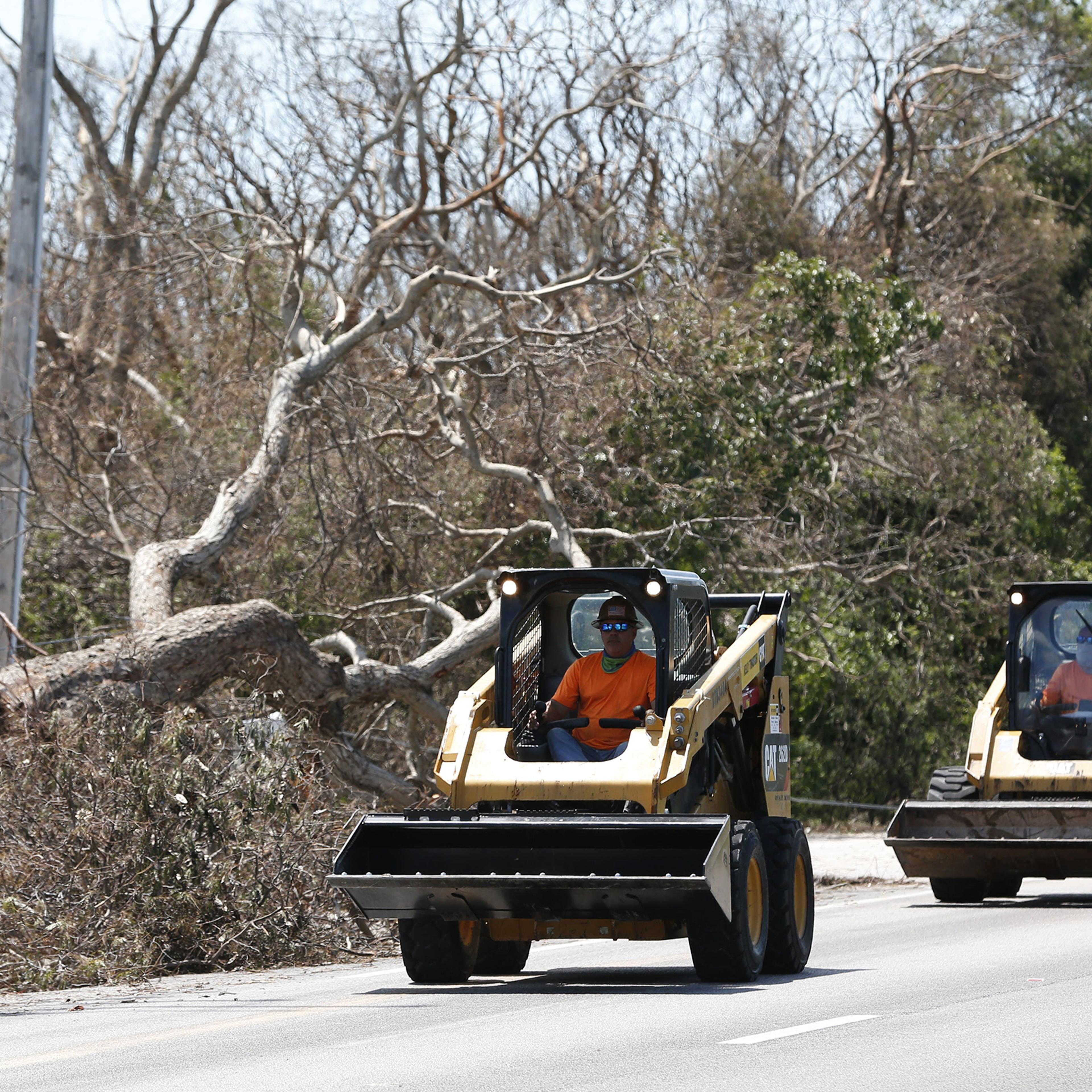 Workers prepare to remove debris, in Key Largo, Fla., in the Florida Keys, Sept. 12, 2017.