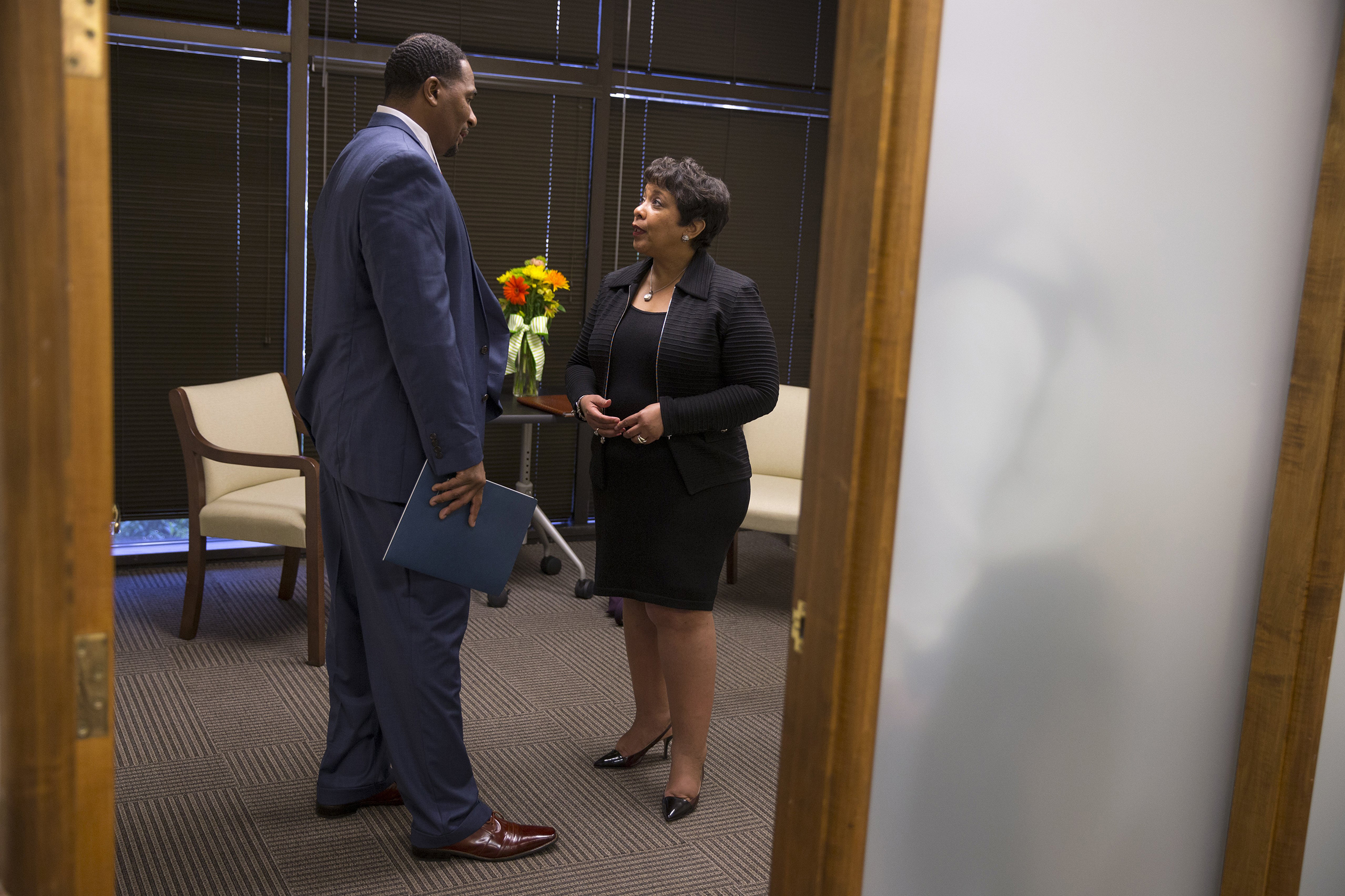 Attorney General Loretta Lynch, right, speaks with Clarence Aaron about his experiences after his release from federal prison during an event to highlight policies that aim to reduce barriers for formerly incarcerated individuals in Mobile, Ala., April 2