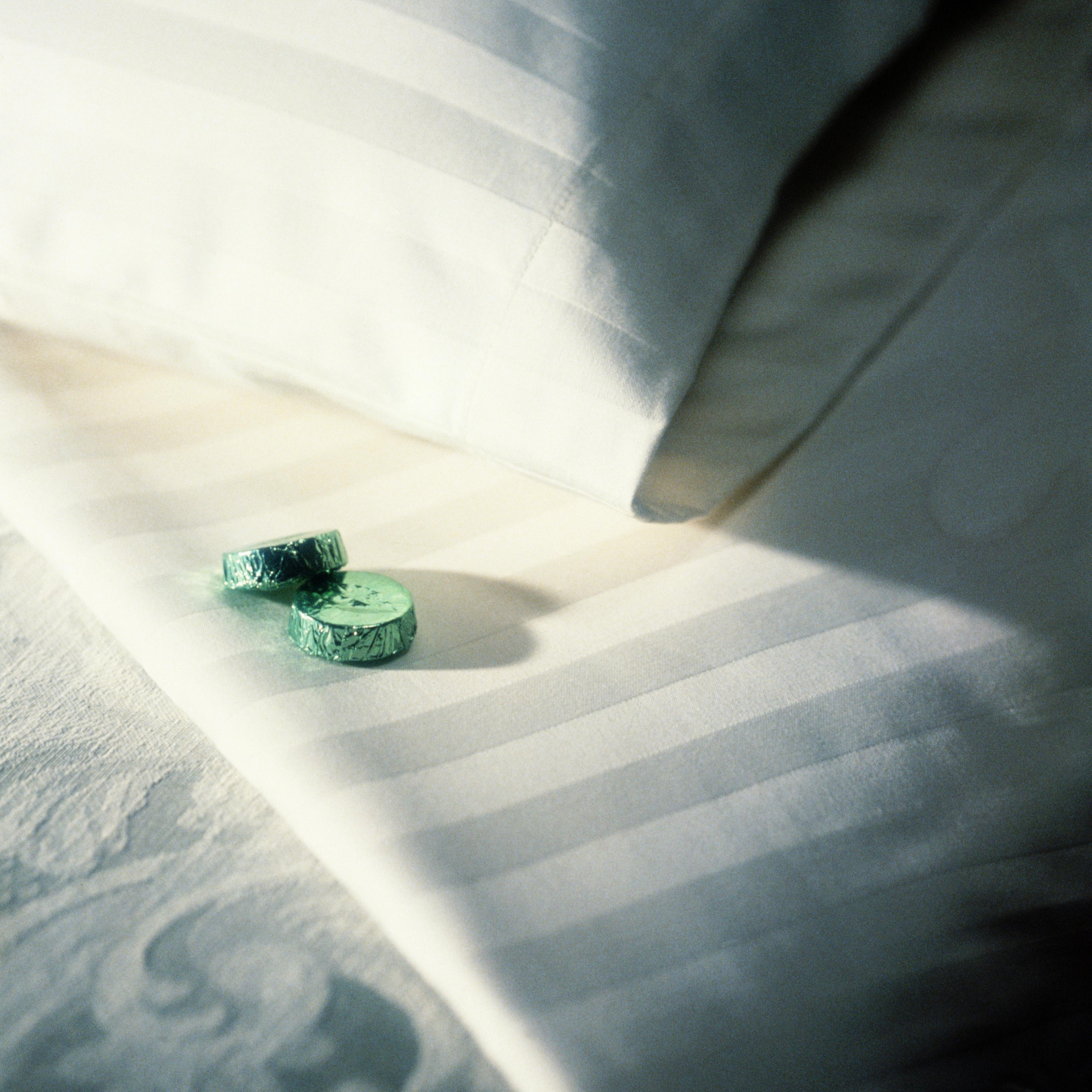 Two mints on hotel bed