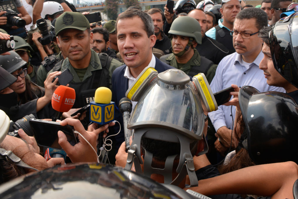 Venezuelan opposition leader Juan Guaidó, recognized by many members of the international community as the country's rightful interim ruler, talks to media out of air force base La Carlota