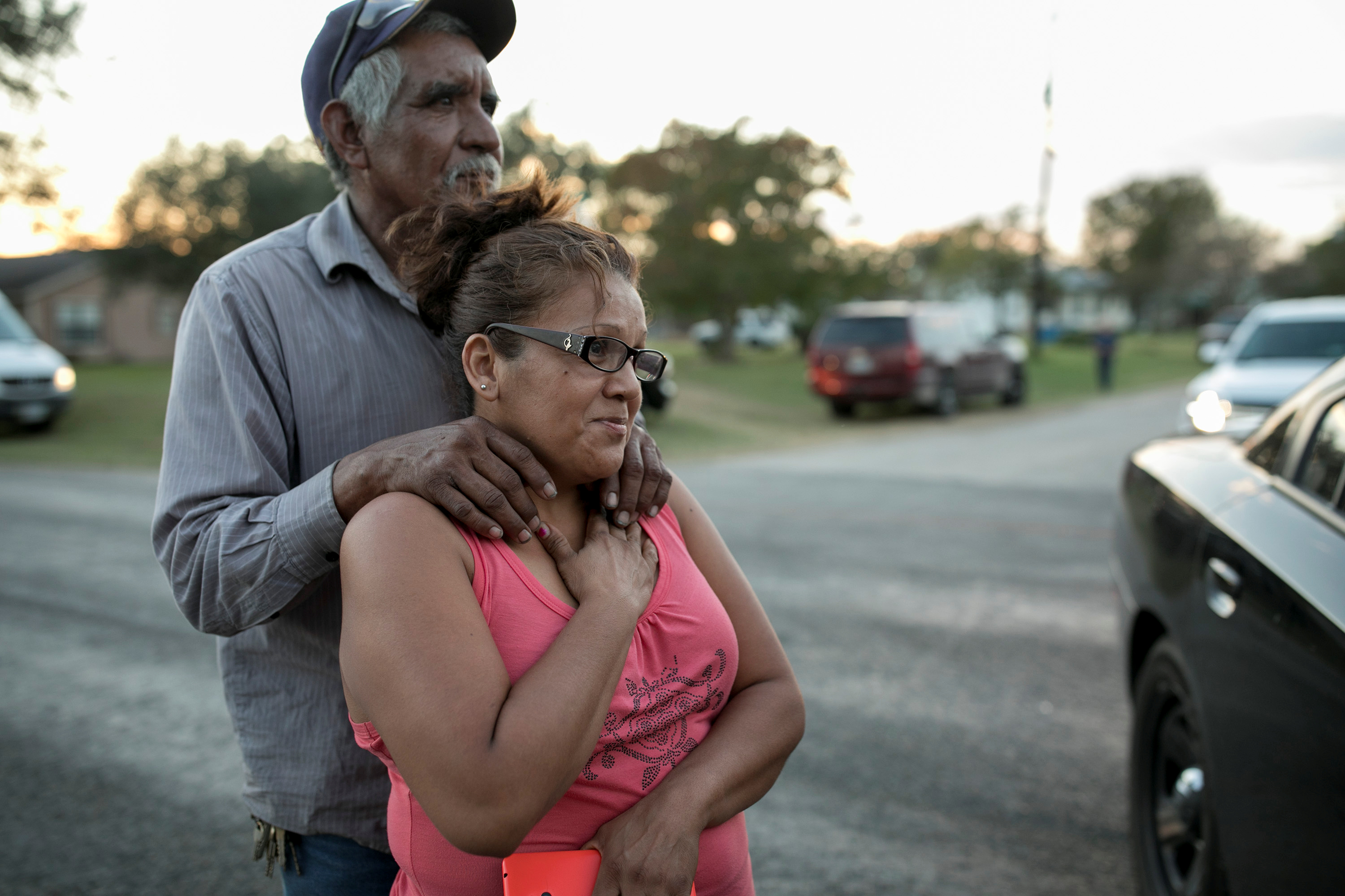 Enrique and Gabby Garcia watch as law enforcement officers investigate a mass shooting at the First Baptist Church in Sutherland Springs