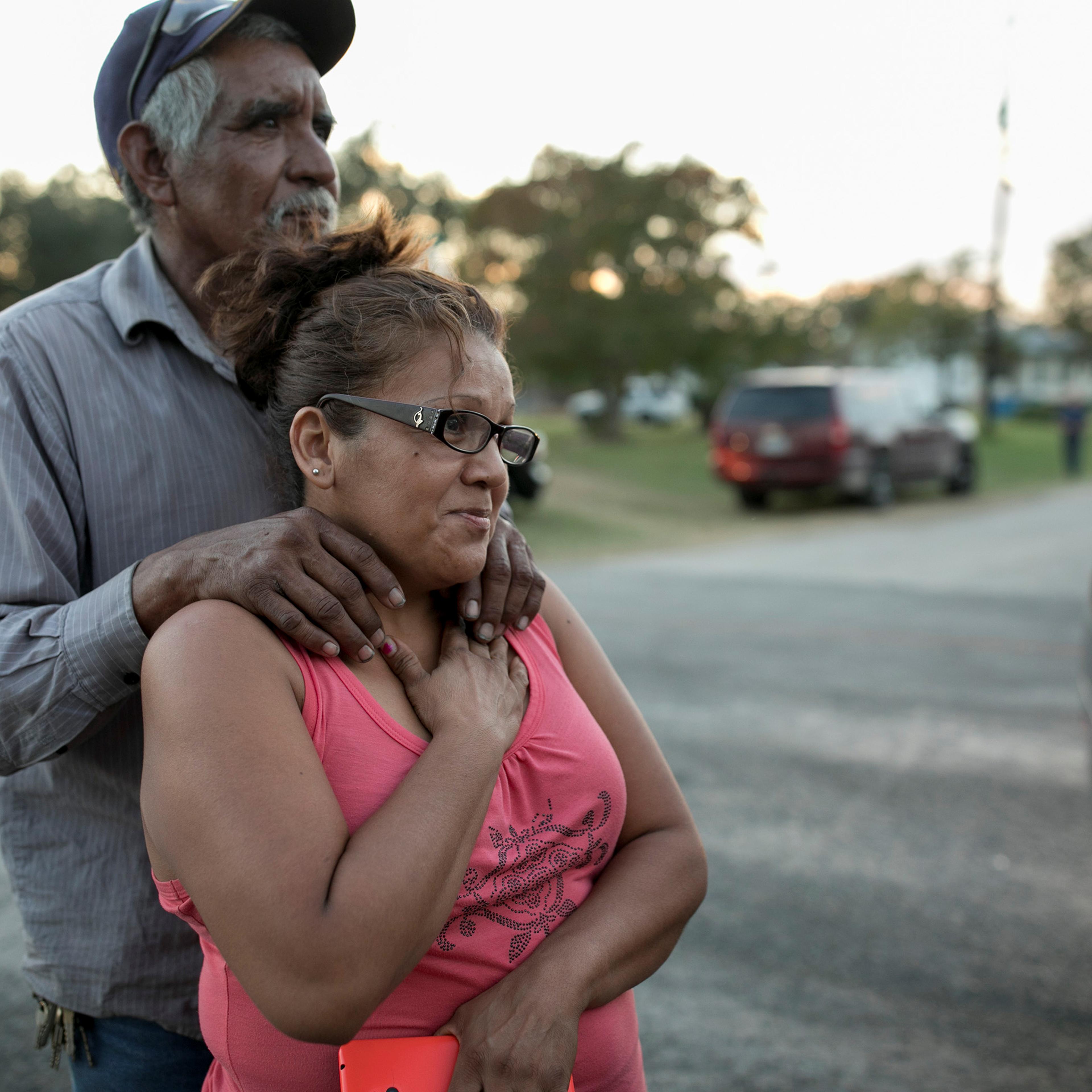 Enrique and Gabby Garcia watch as law enforcement officers investigate a mass shooting at the First Baptist Church in Sutherland Springs