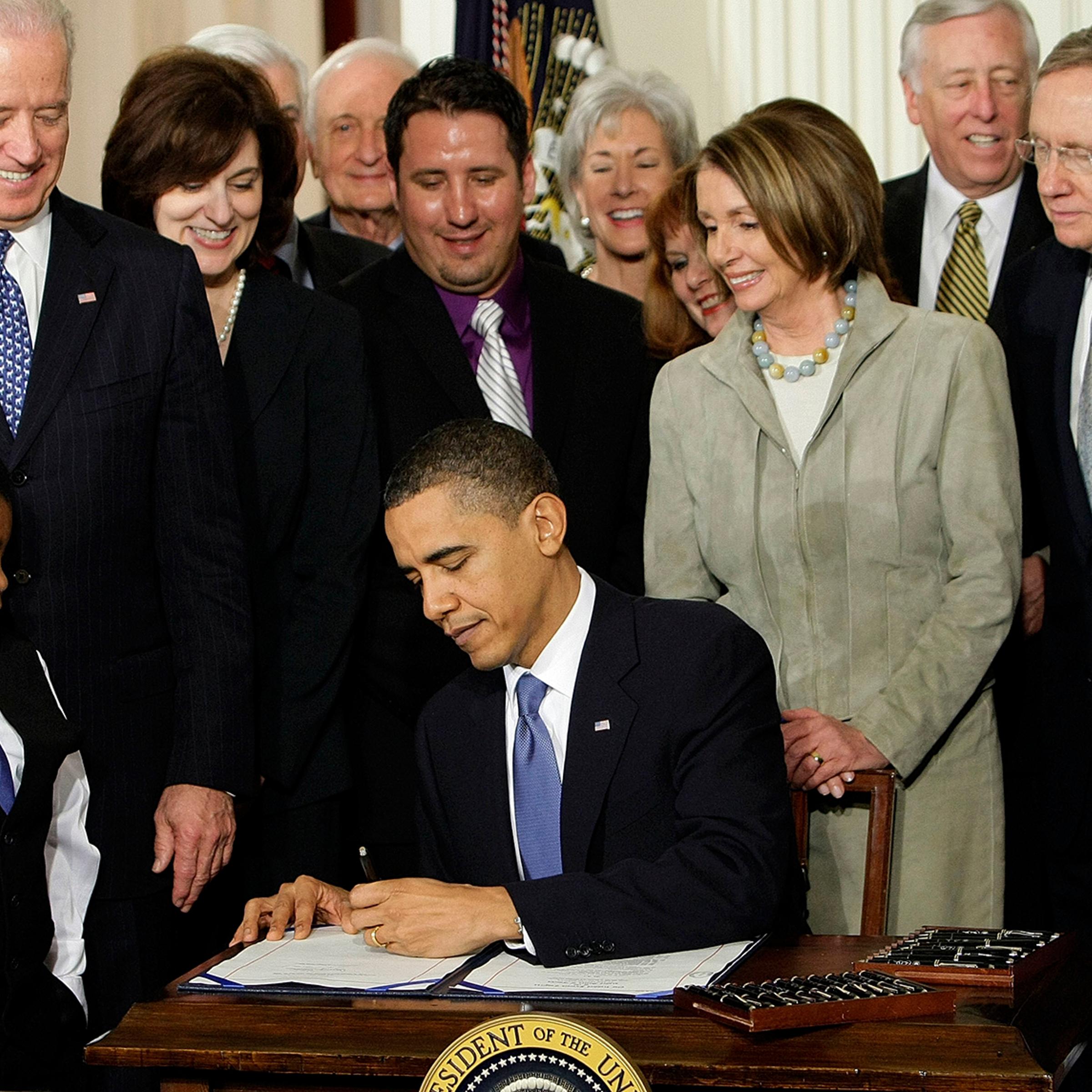 In this March 23, 2010 file photo, President Barack Obama signs the health care bill in the East Room of the White House in Washington.